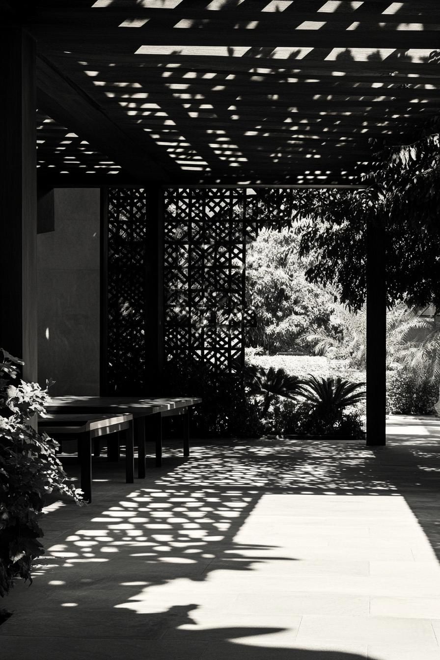 inner courtyard of a modern house with a large pattern pavillion filtering light shadows dropping on garden plants