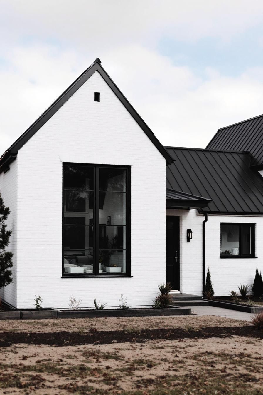 White house with black trim against a cloudy sky