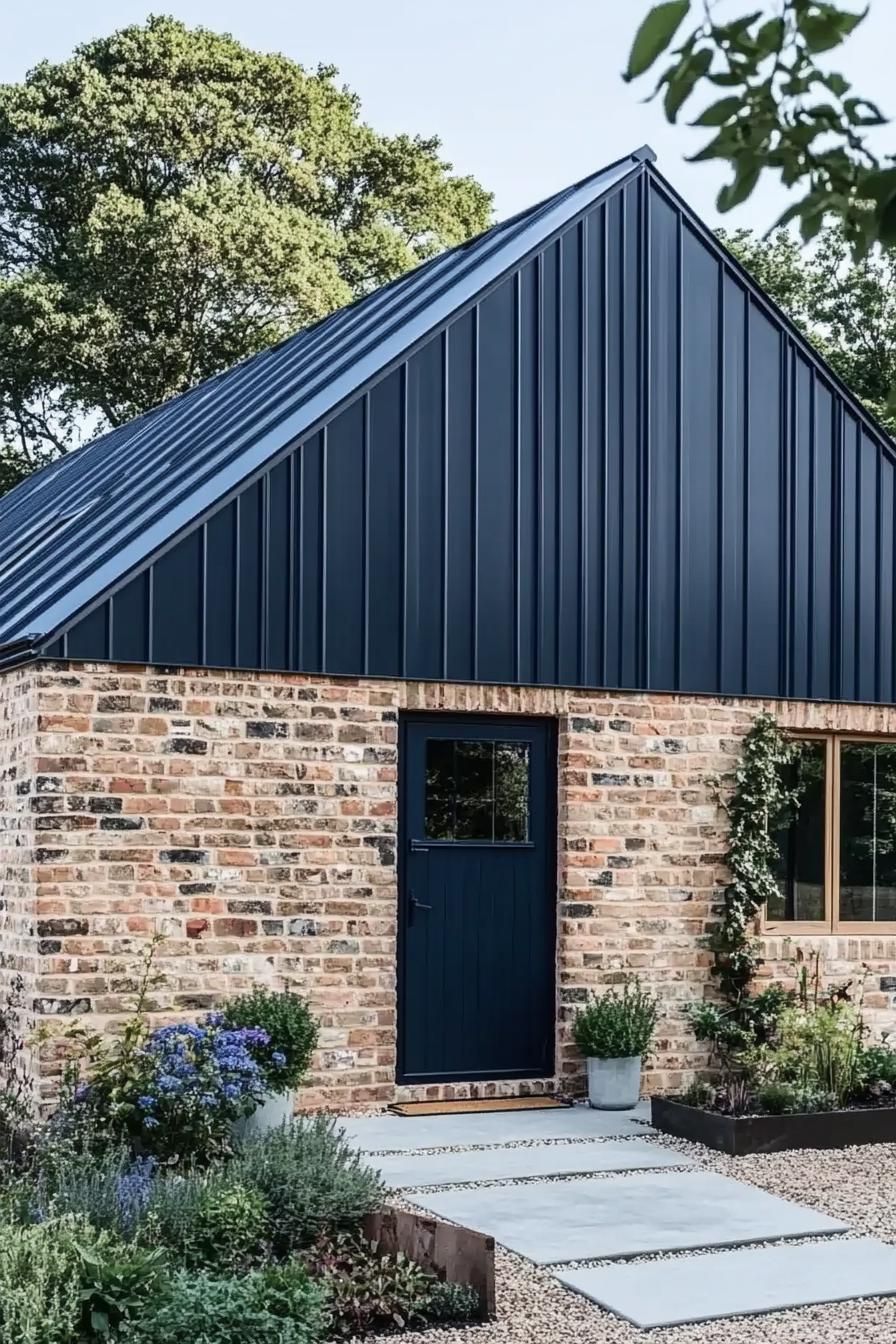 Modern barn house with a black metal roof and brick walls