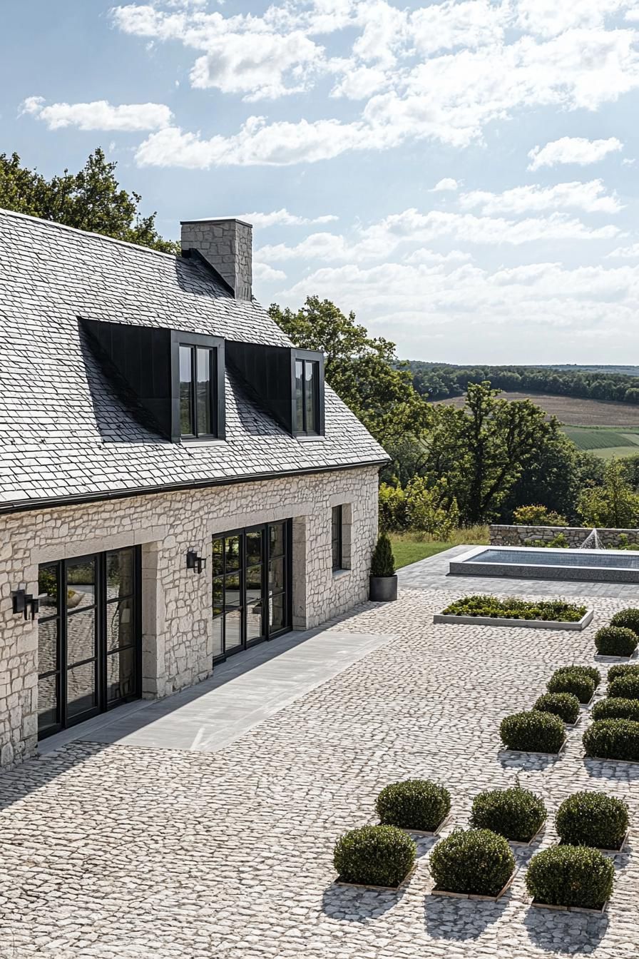 Modern stone house with a slate roof and cobblestone courtyard