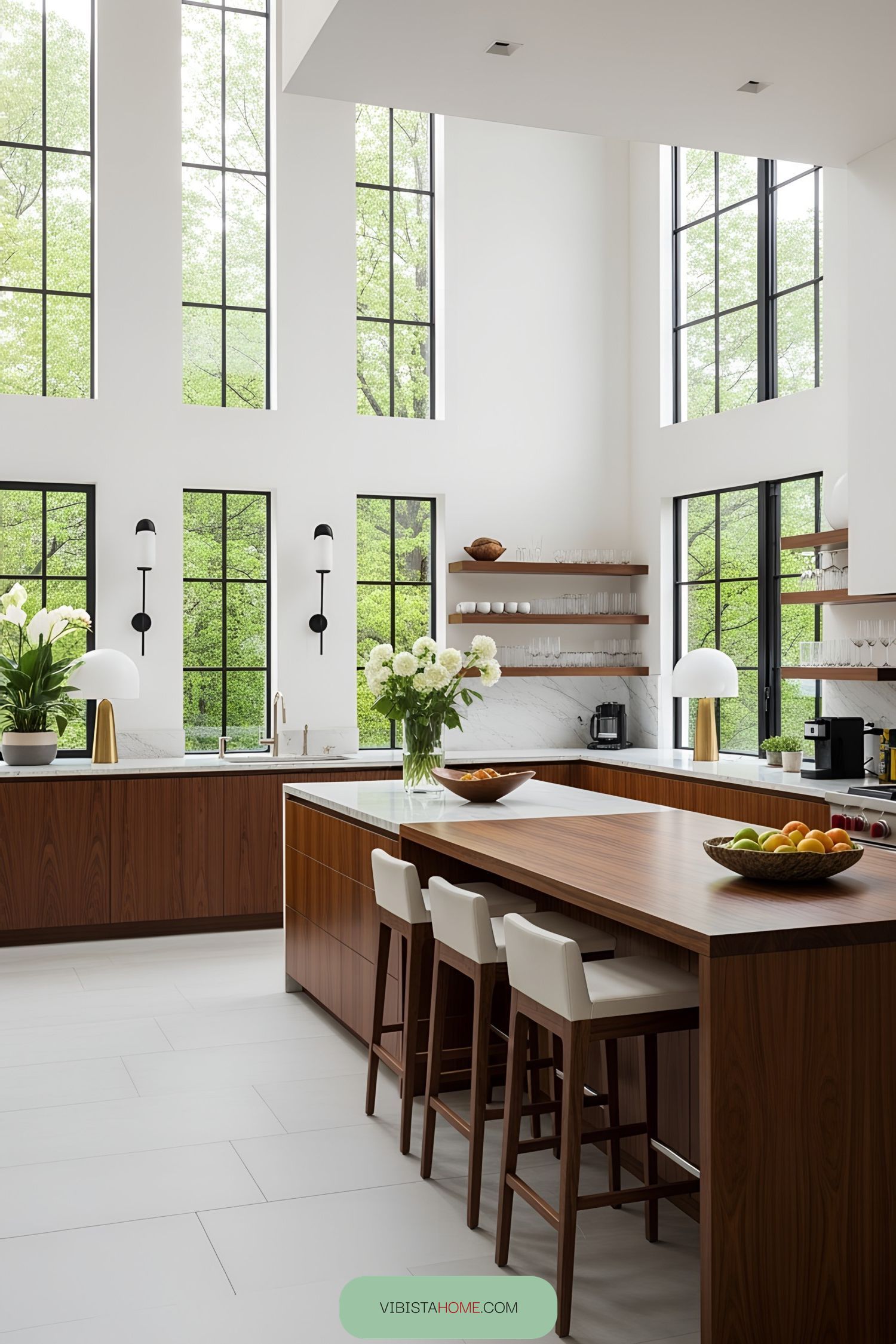 Modern kitchen with large windows, wooden accents, and white countertops