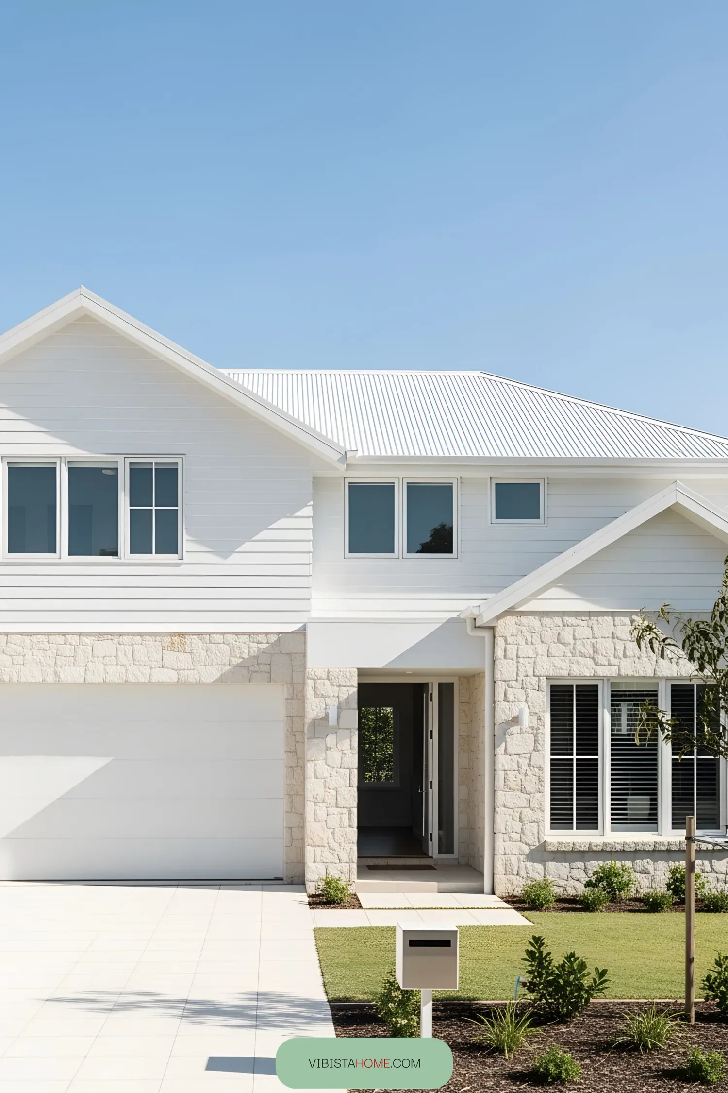 Modern coastal home with white stone and siding exterior