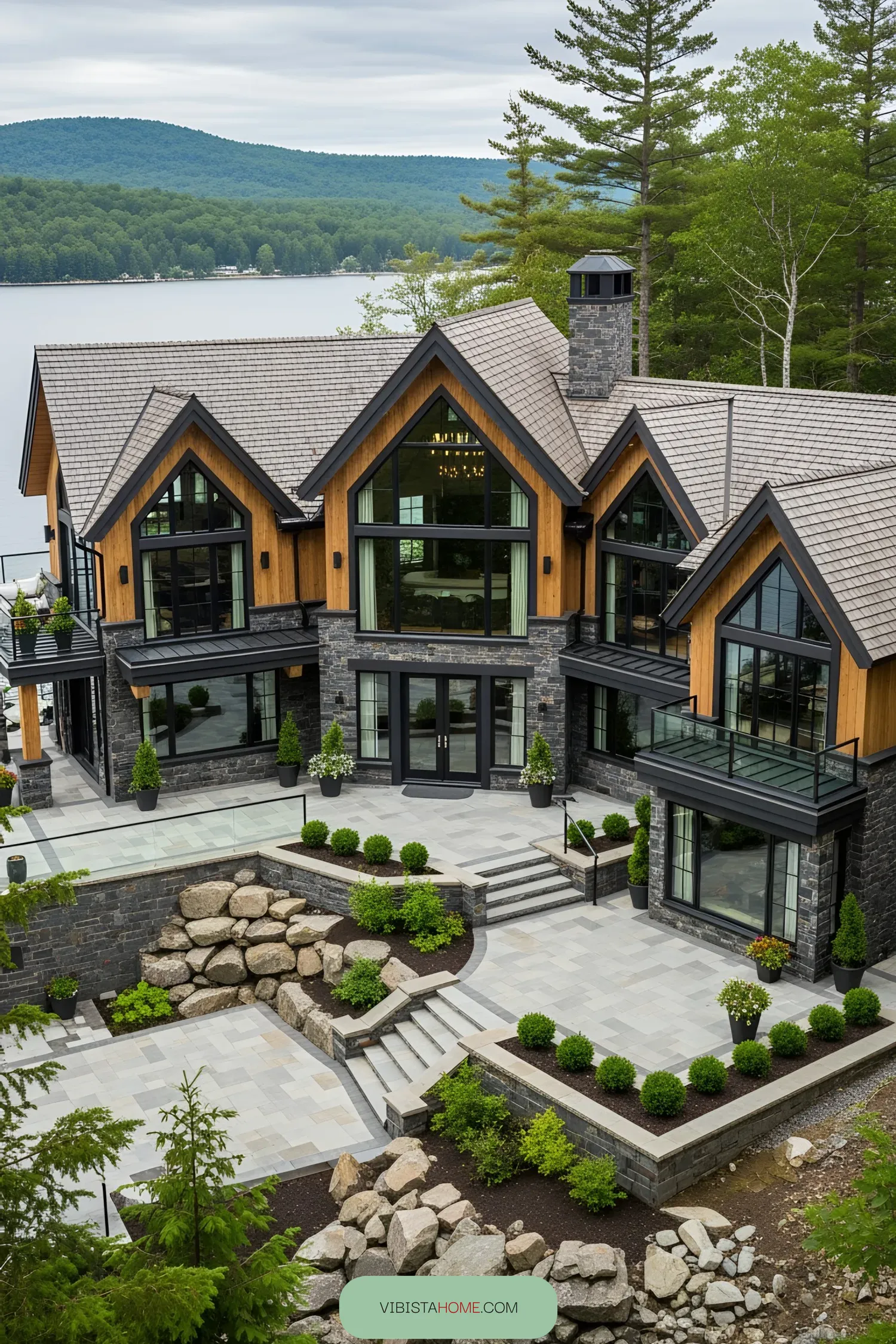 Luxurious lakeside house with large windows and stone facade