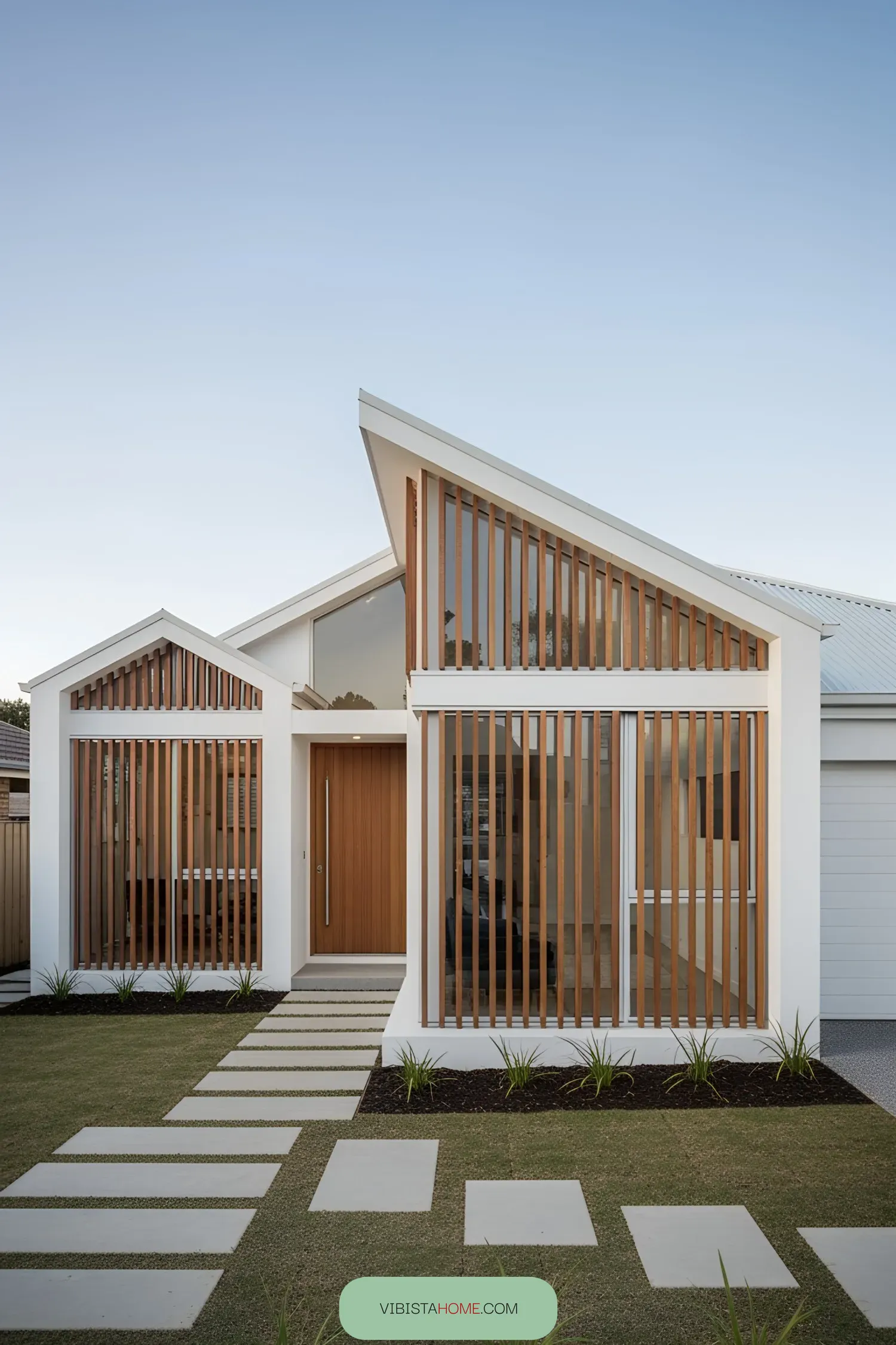 Modern house with angular design, wood slats, and lush lawn