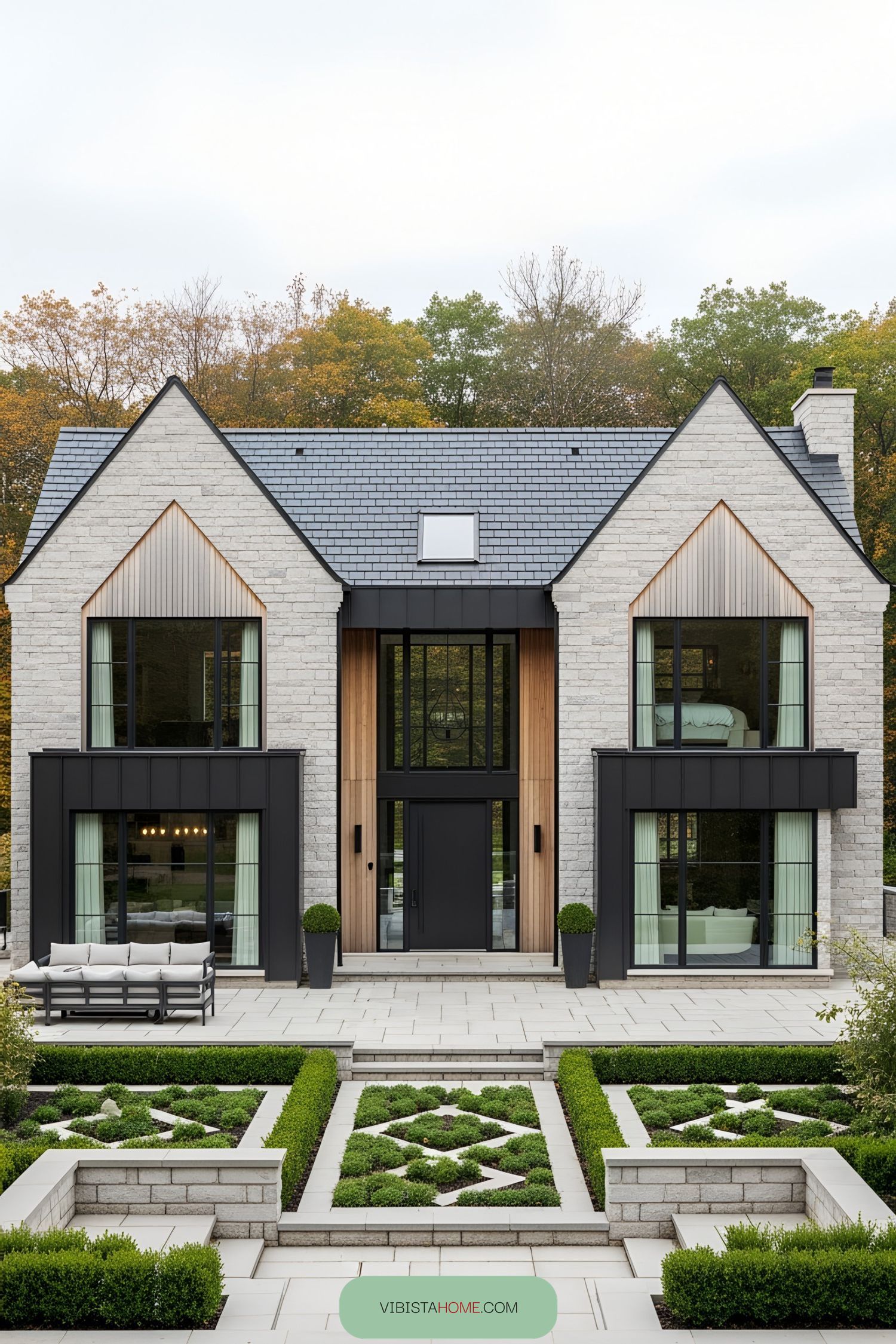 Elegant brick farmhouse with large windows and manicured garden