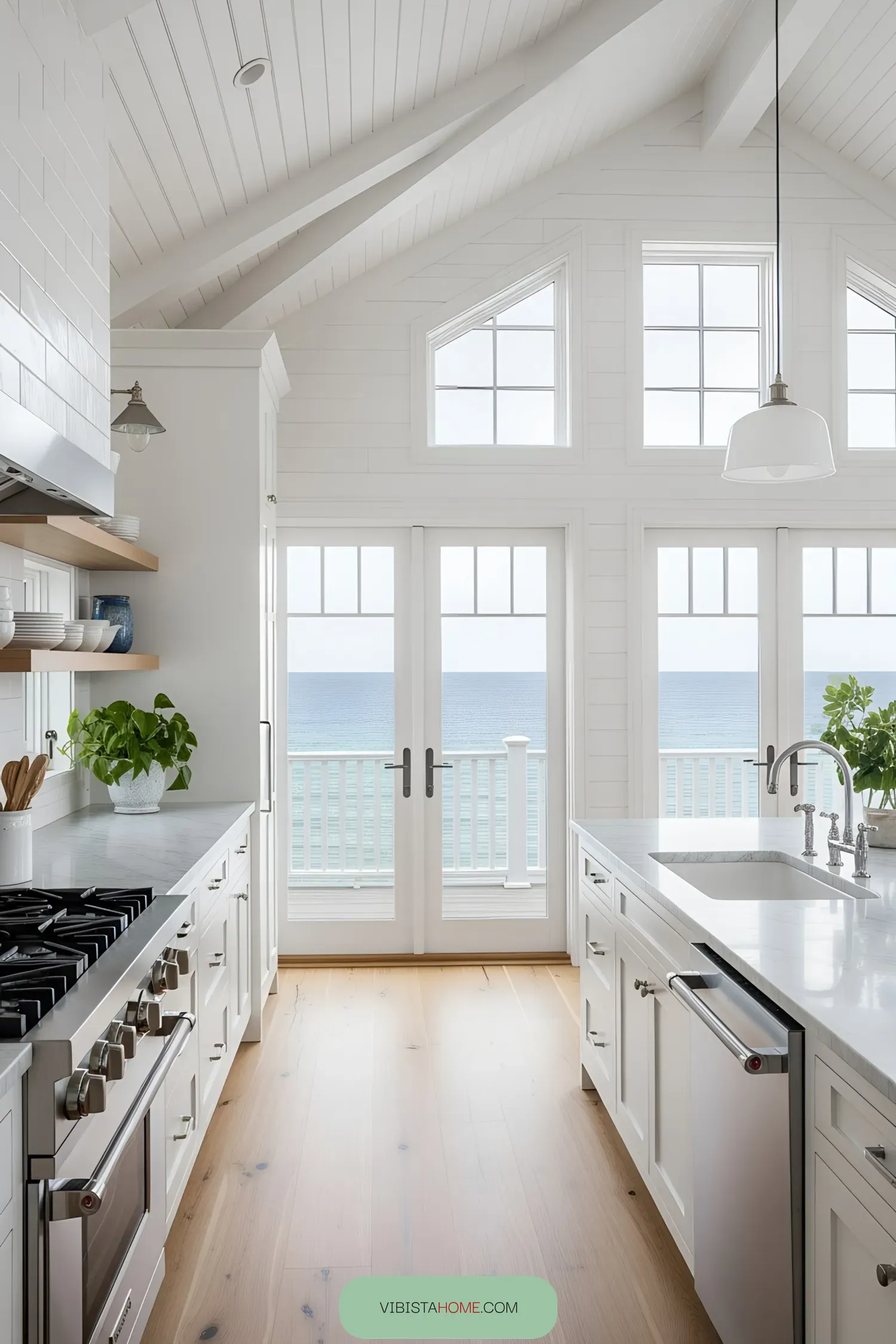 Bright kitchen overlooking the ocean with large windows and a beautiful interior