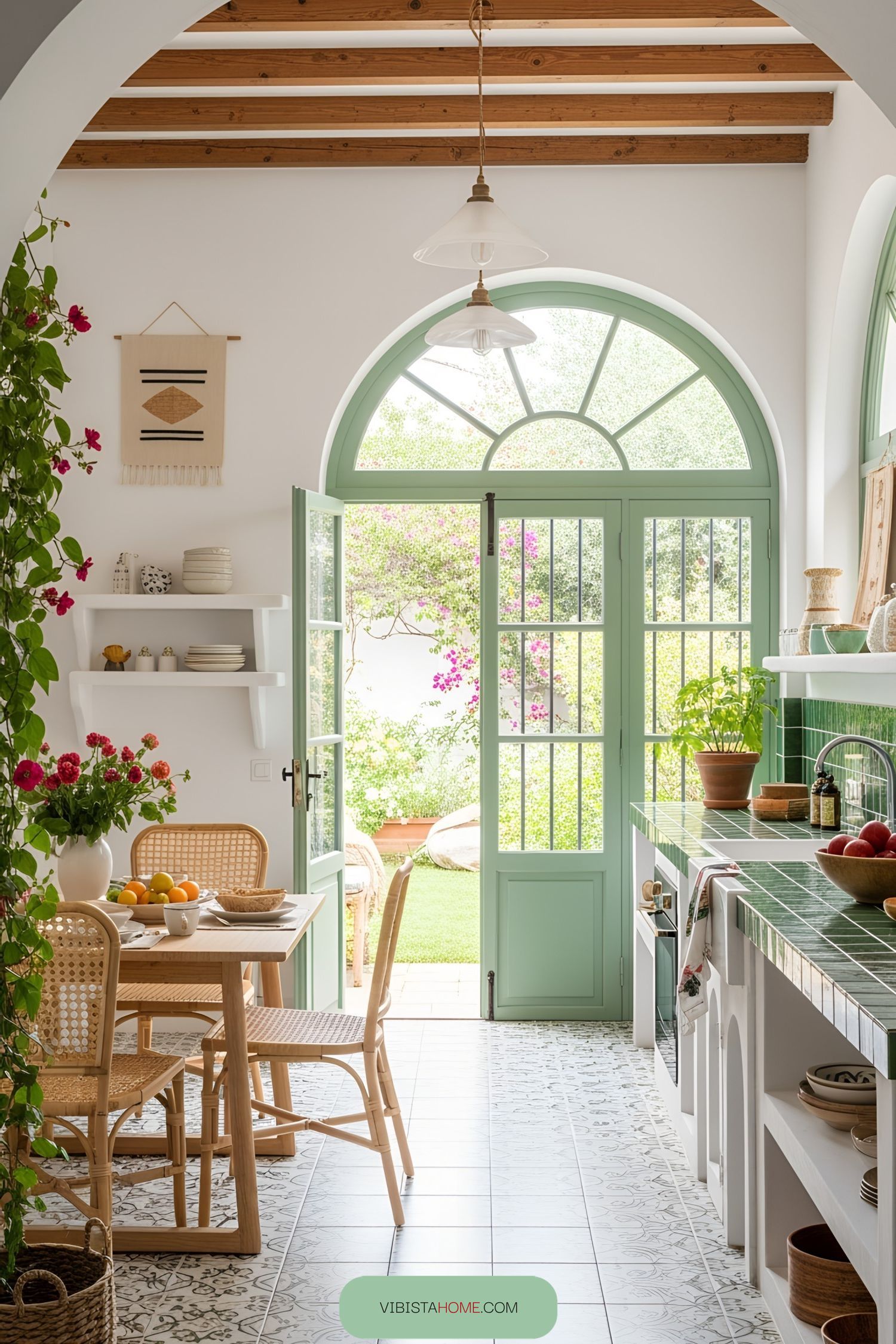 Bright Spanish kitchen with green tiles and wicker chairs