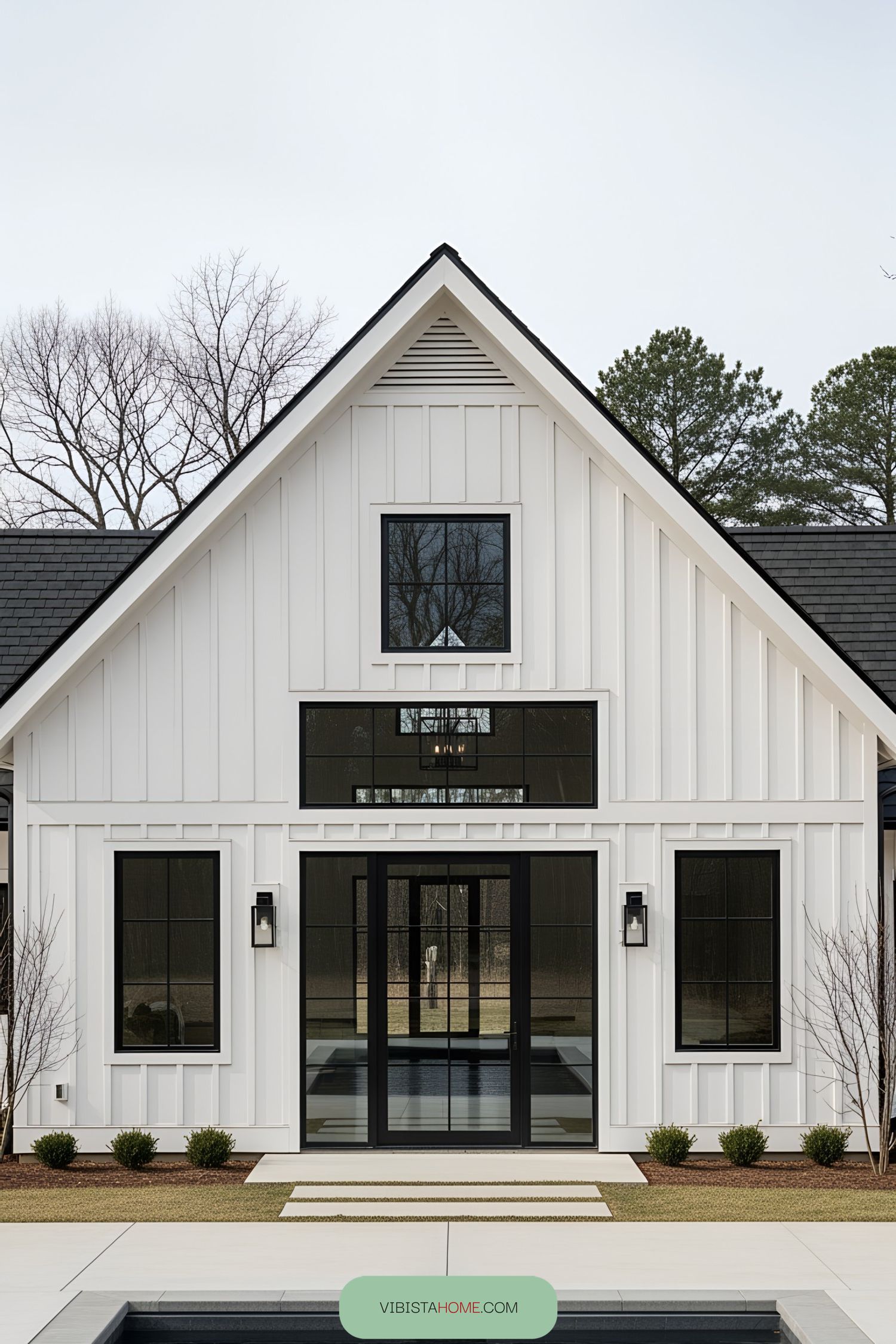 White barn-style house with large windows and a sleek design