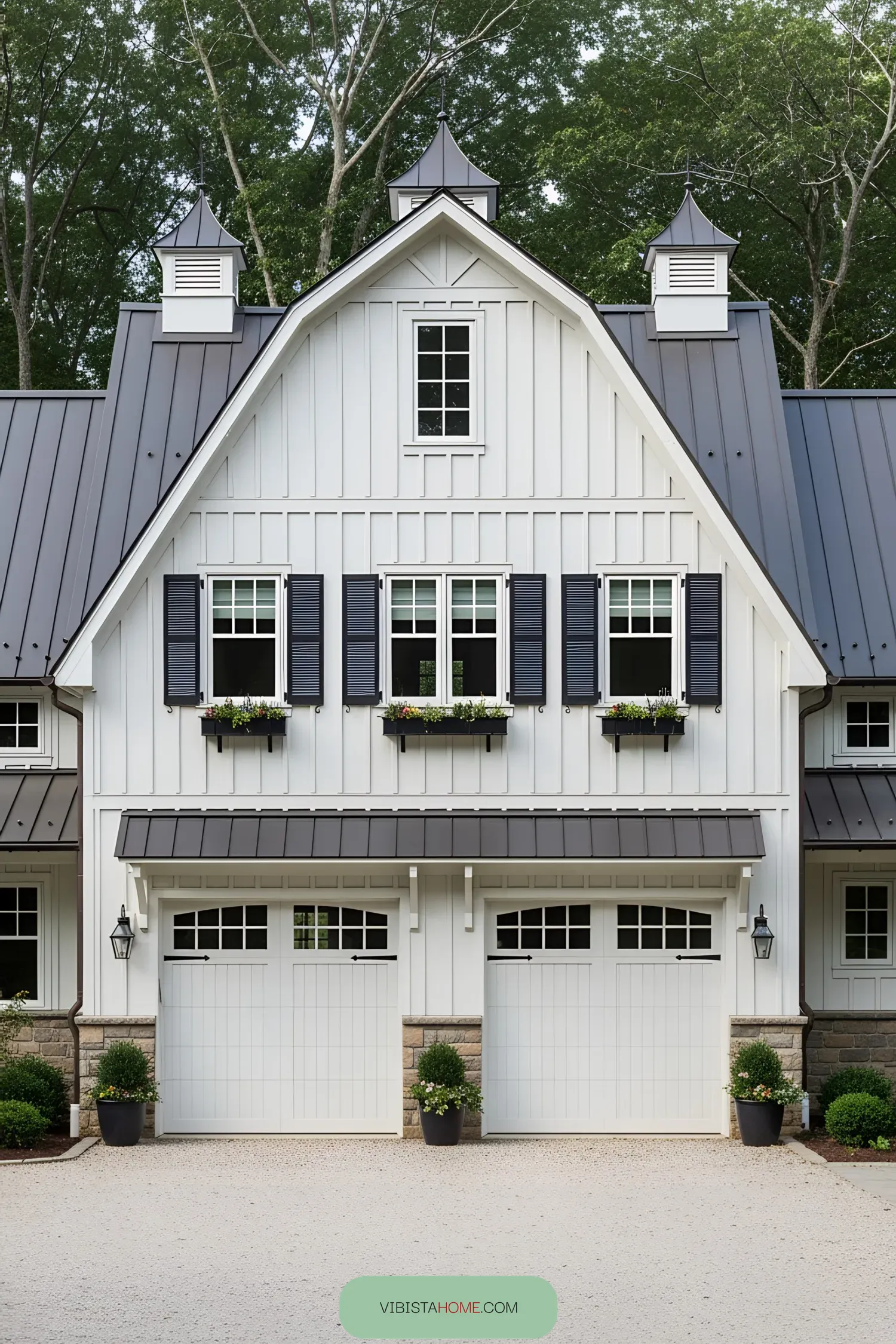 White farmhouse with large garage and black shutters