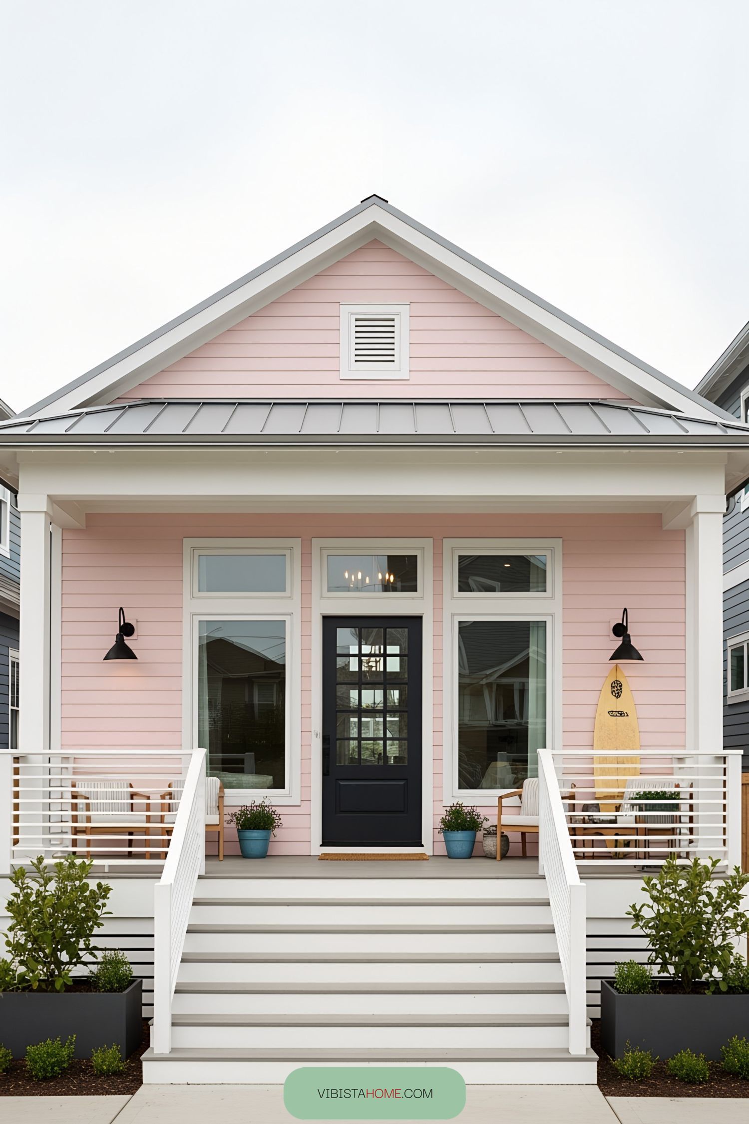 Charming pink bungalow with a surfboard by the door