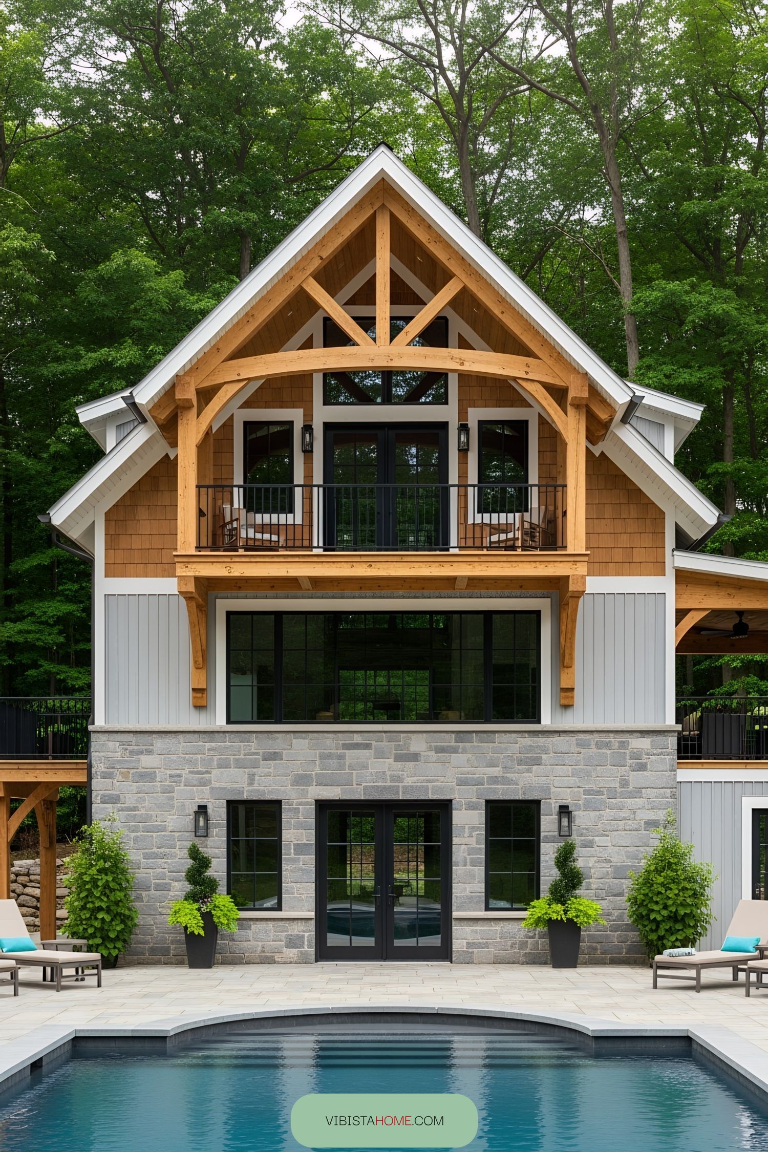 Barn pool house with stone facade and upper balcony