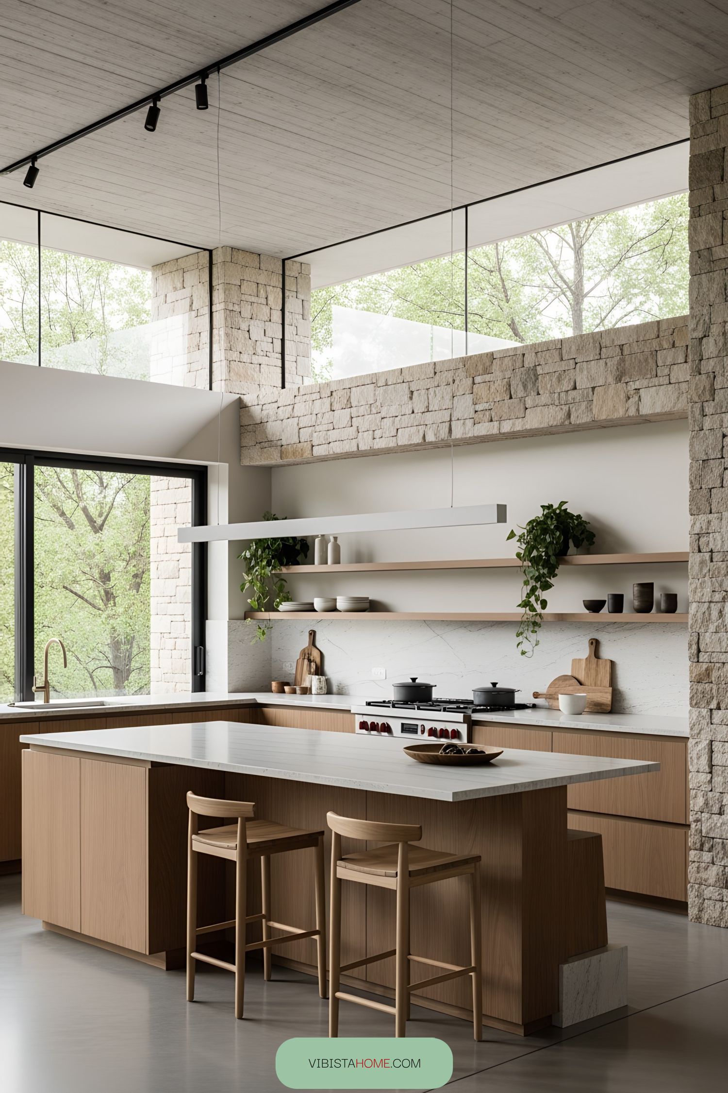 Modern kitchen with stone walls, large windows, and warm wood accents