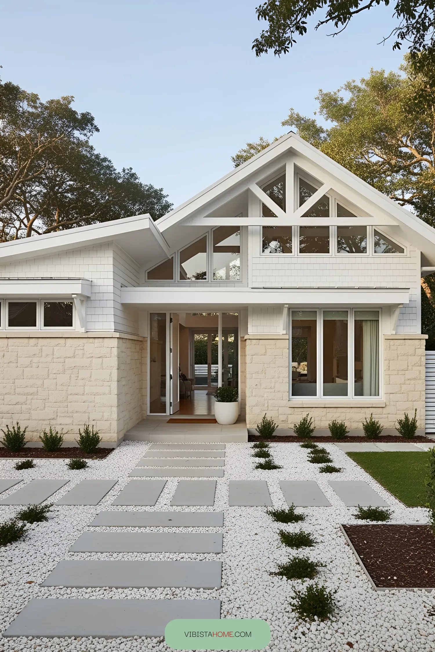 Modern coastal house with stone façade and geometric pathway