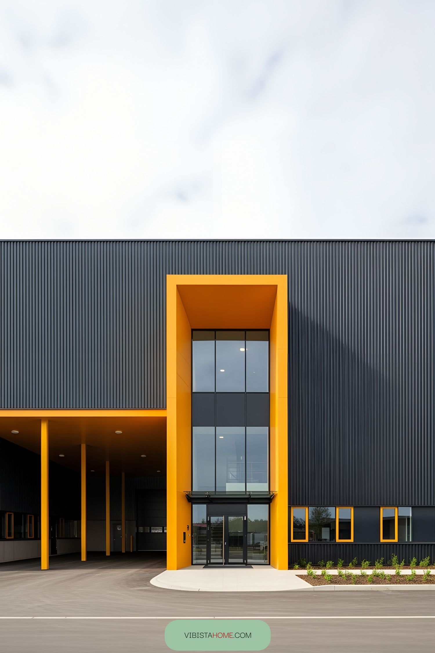 Modern factory facade with bold orange accents