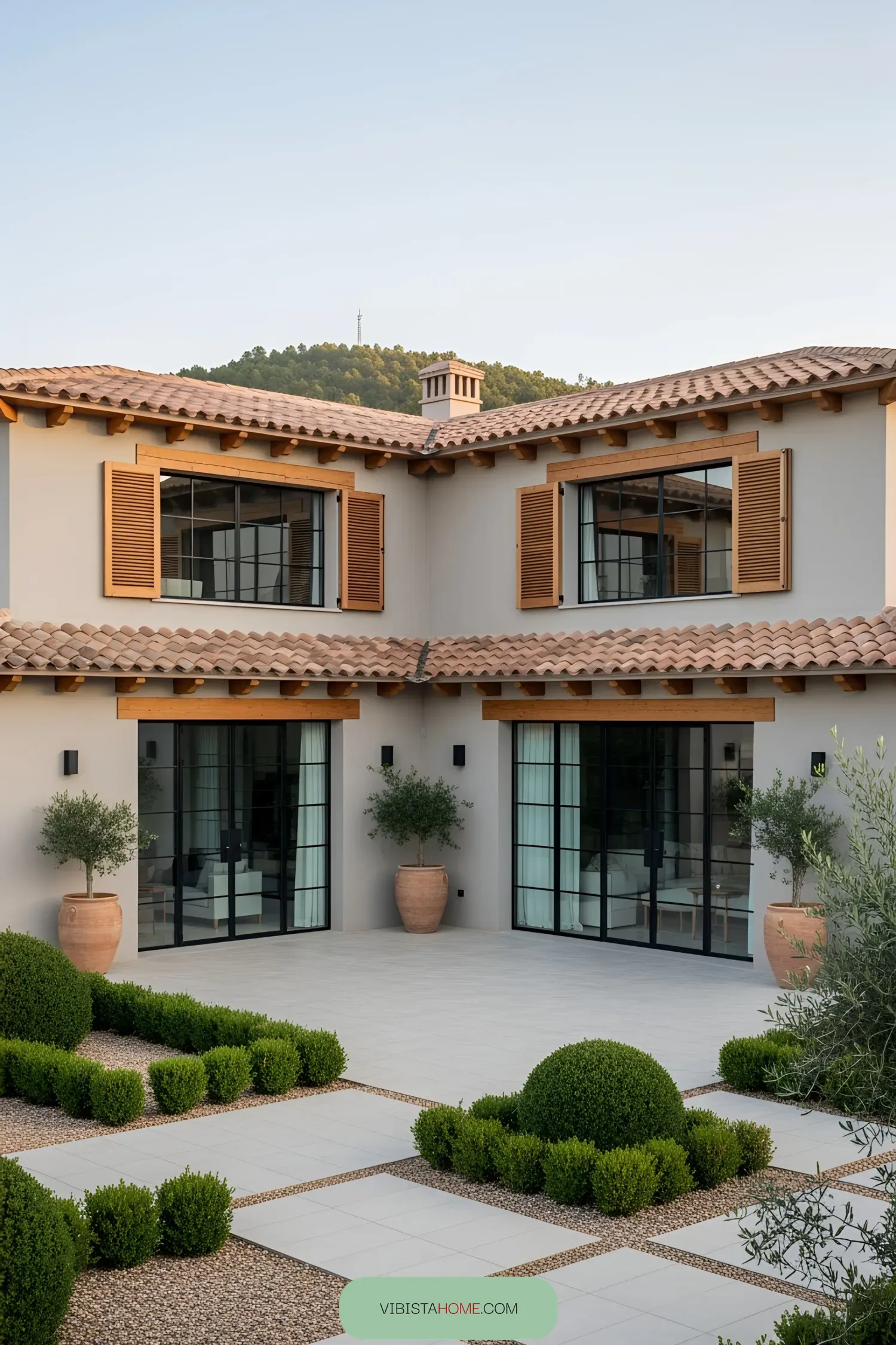 Spanish farmhouse with terracotta roof and lush courtyard