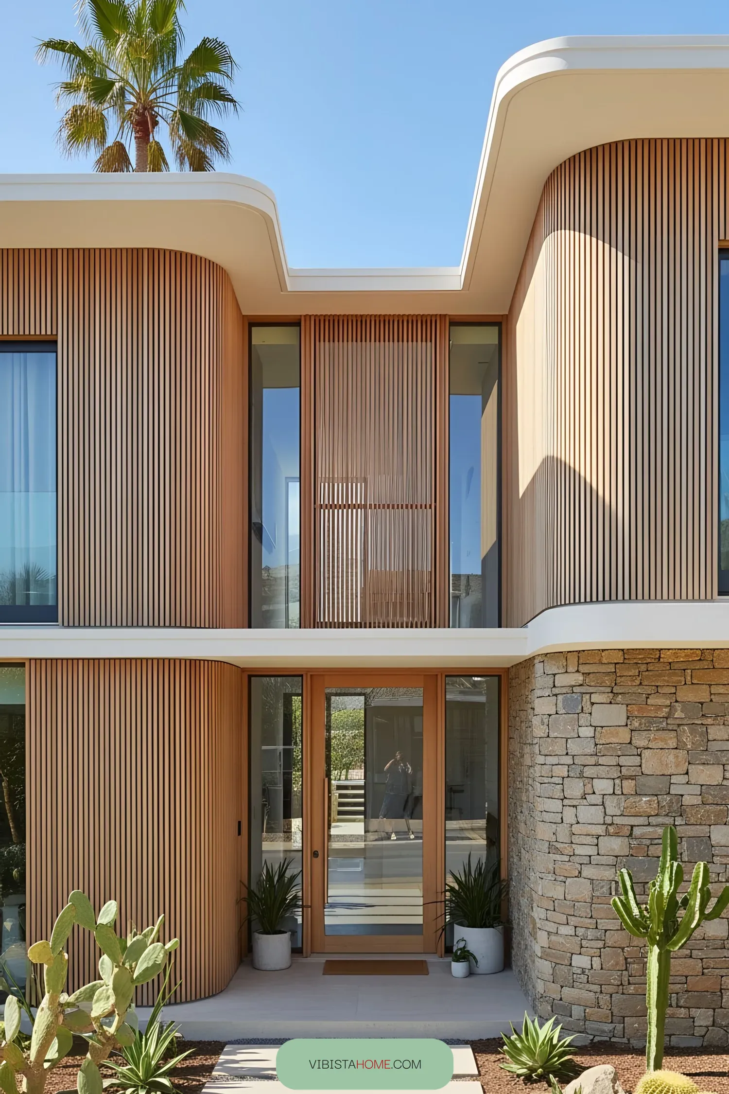 Modern coastal home with palm tree and elegant wooden facade