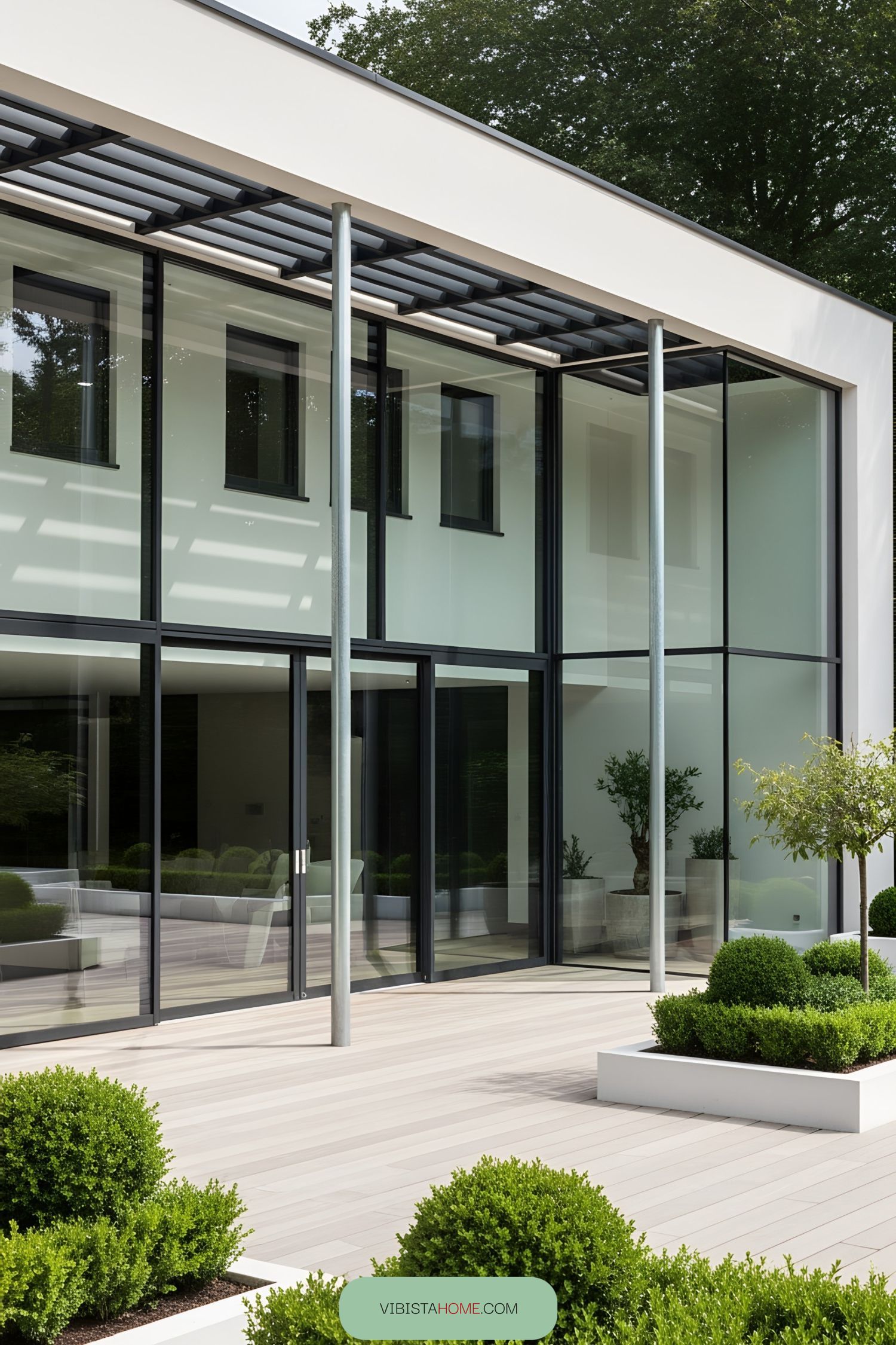 Modern glass terrace with plants and sofas