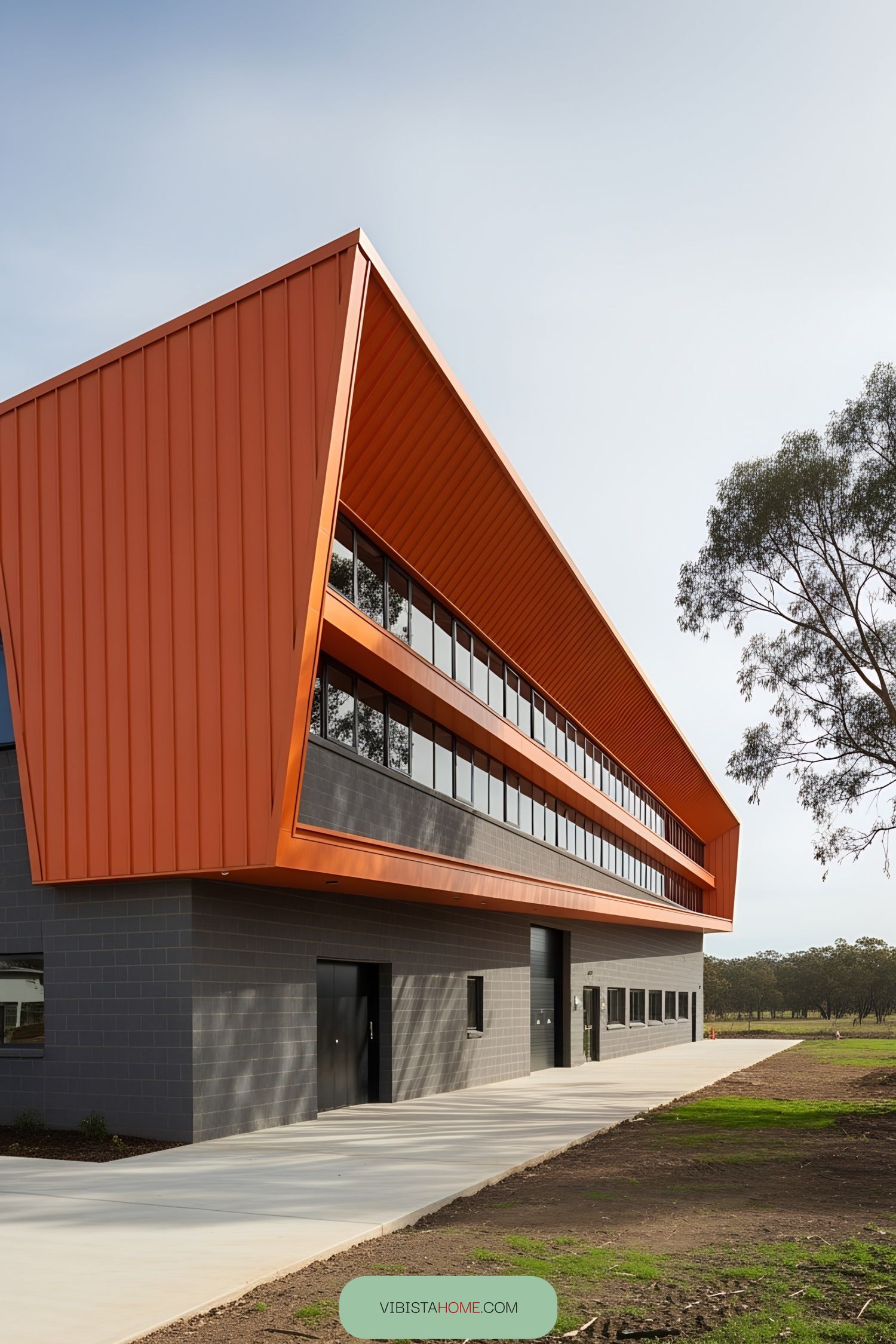 Factory building with striking orange façade and big windows