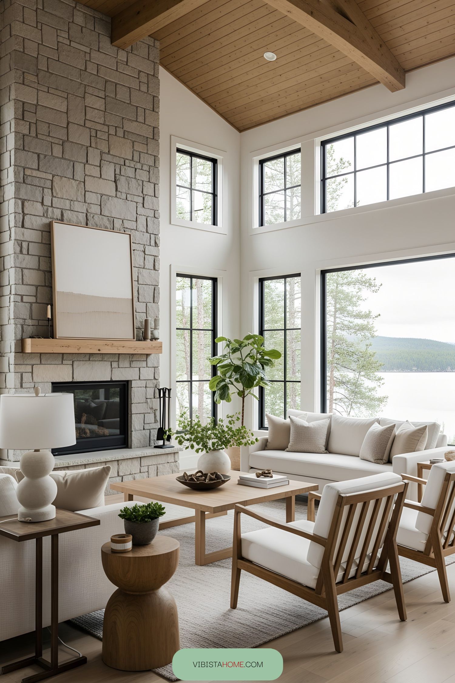 Spacious living room with large windows and stone fireplace