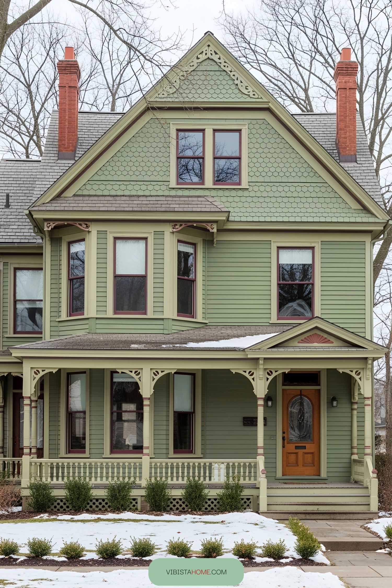 Charming green Victorian house with detailed trim