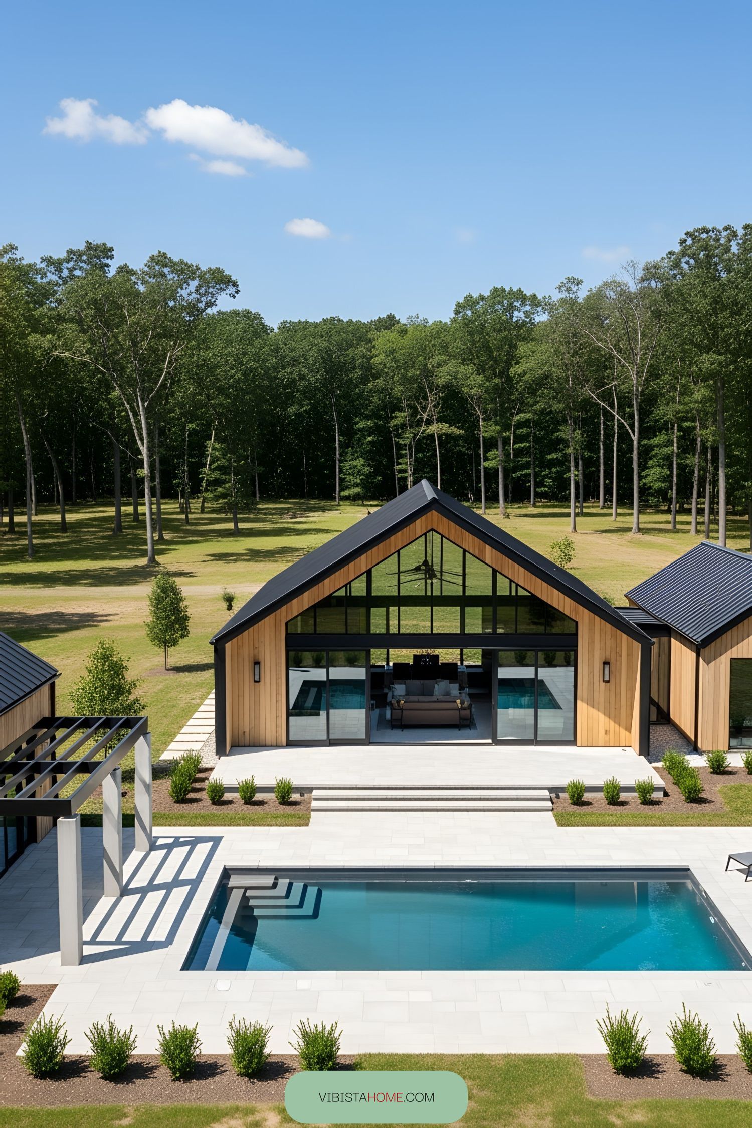 Contemporary barn-style pool house with patio and pool