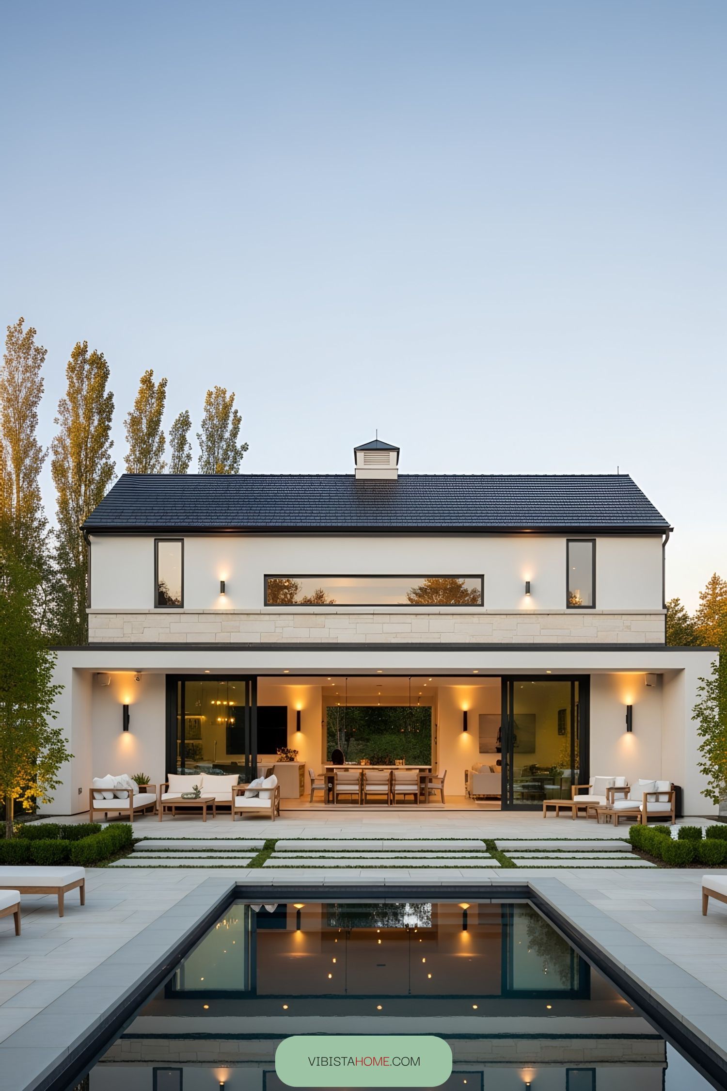Stylish white barn pool house with modern features and cozy seating