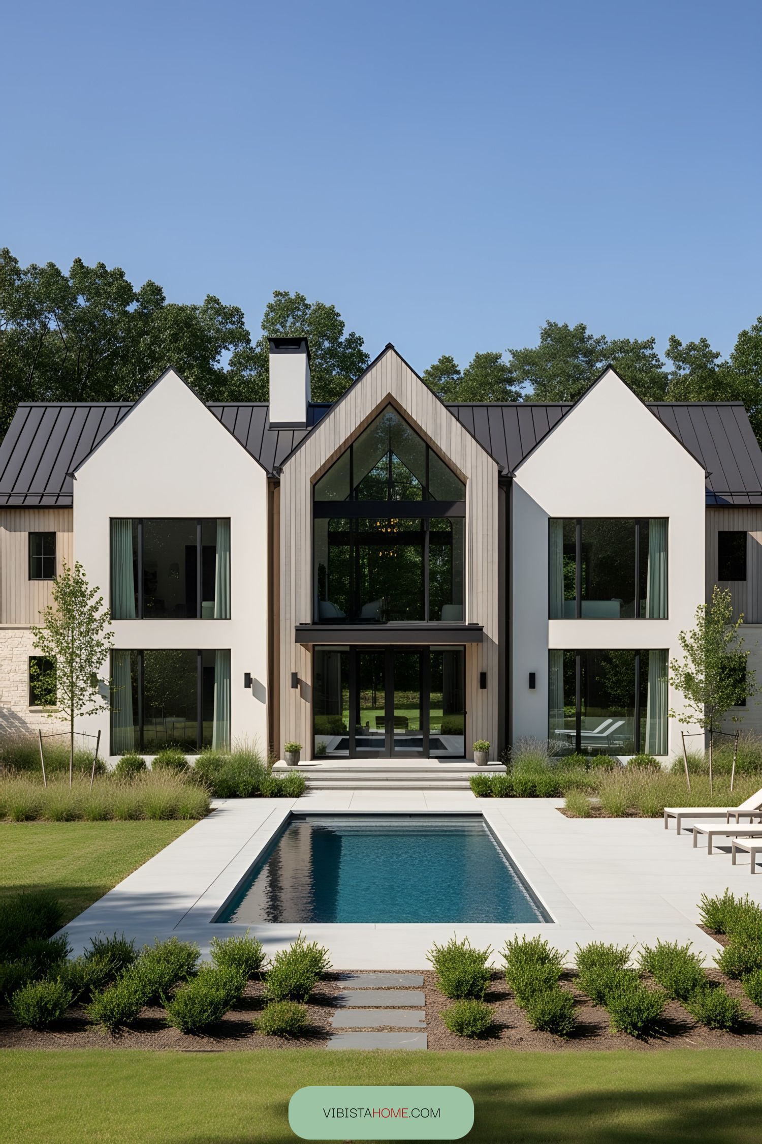 Contemporary farmhouse with large glass windows and a pool
