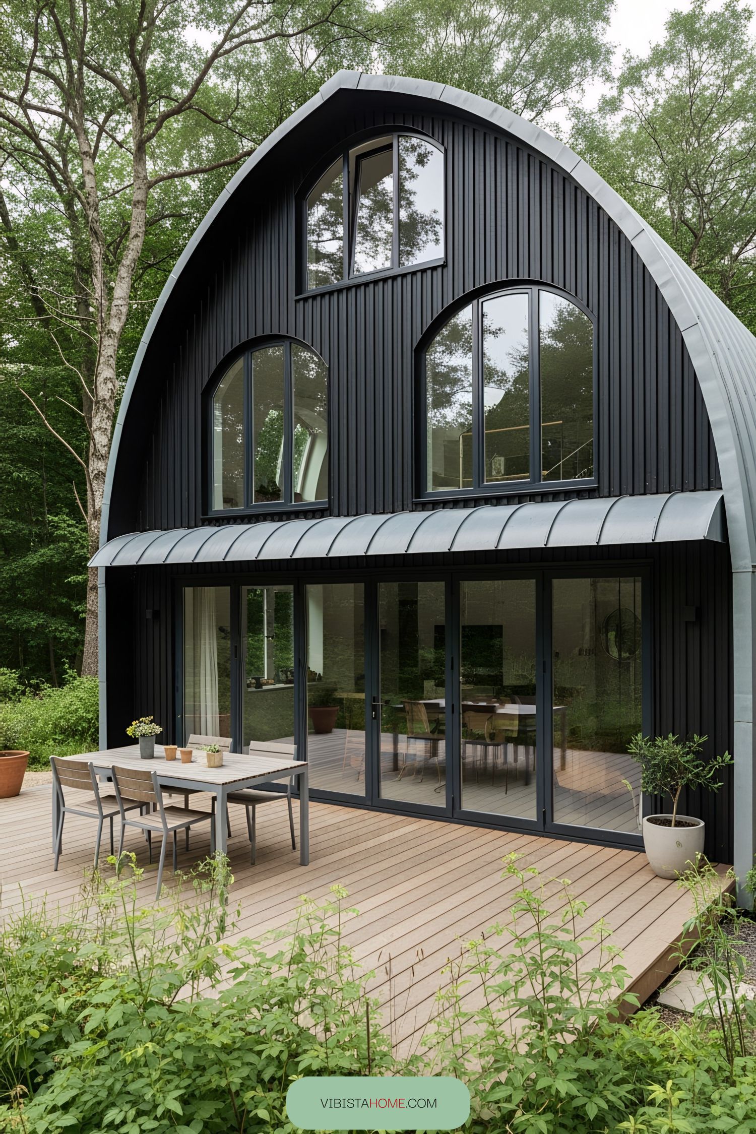 Modern black house with large windows and a curved roof