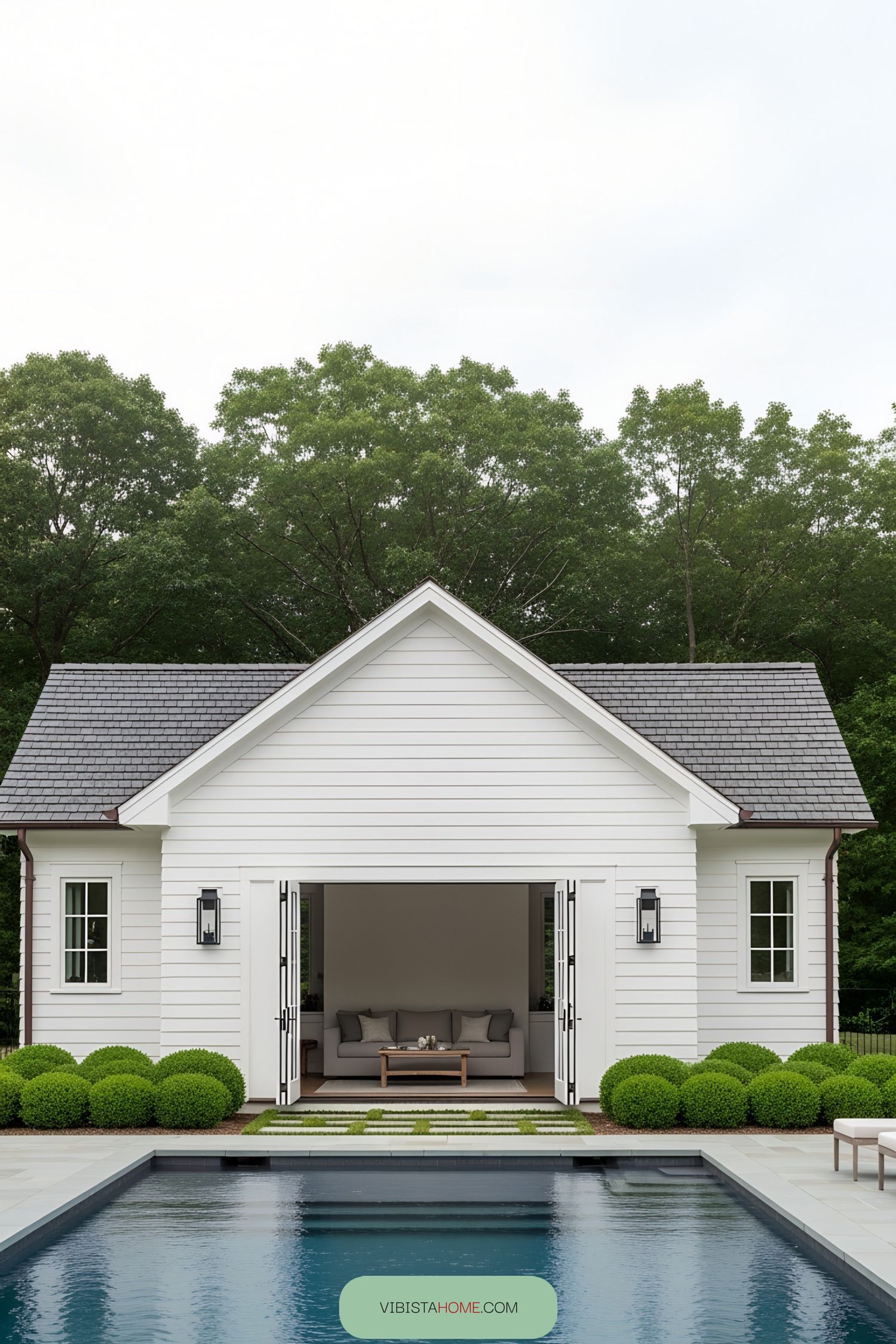 Small white pool house with open doors