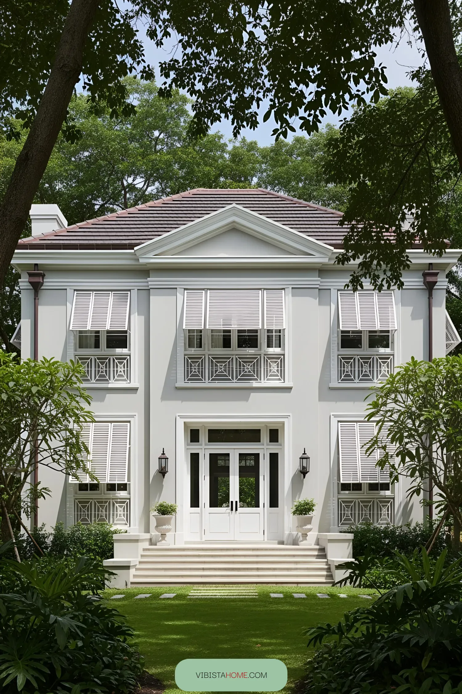 White colonial house with lush greenery