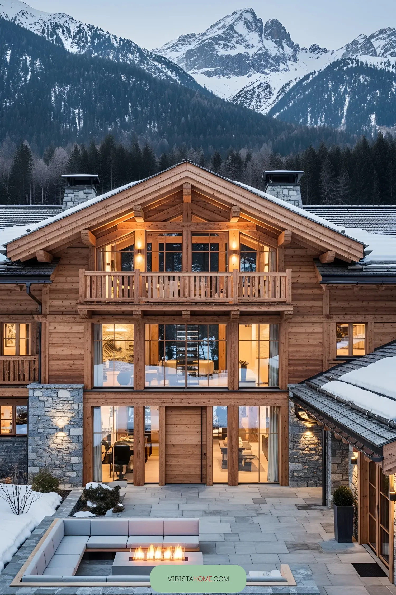A grand wooden chalet amidst a mountain backdrop