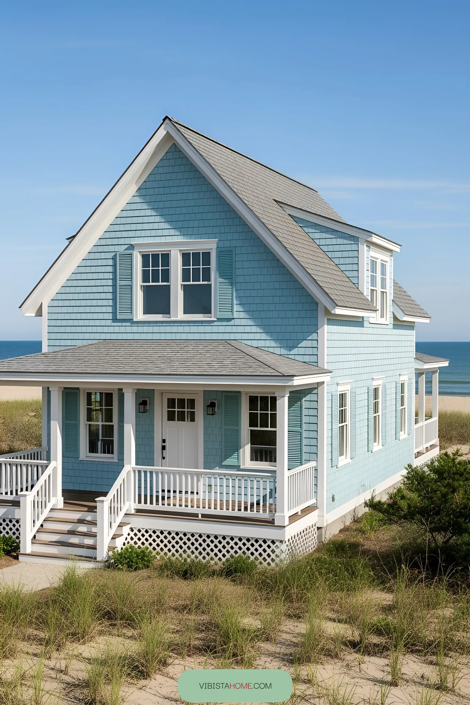 Coastal house with blue siding and white trim