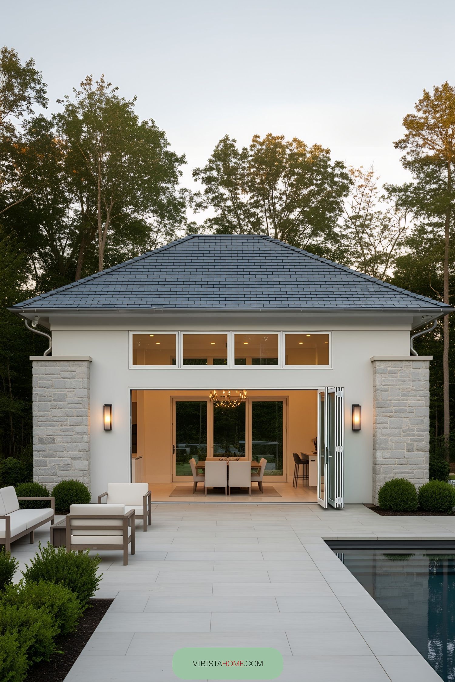 Modern pool house with open doors and seating area