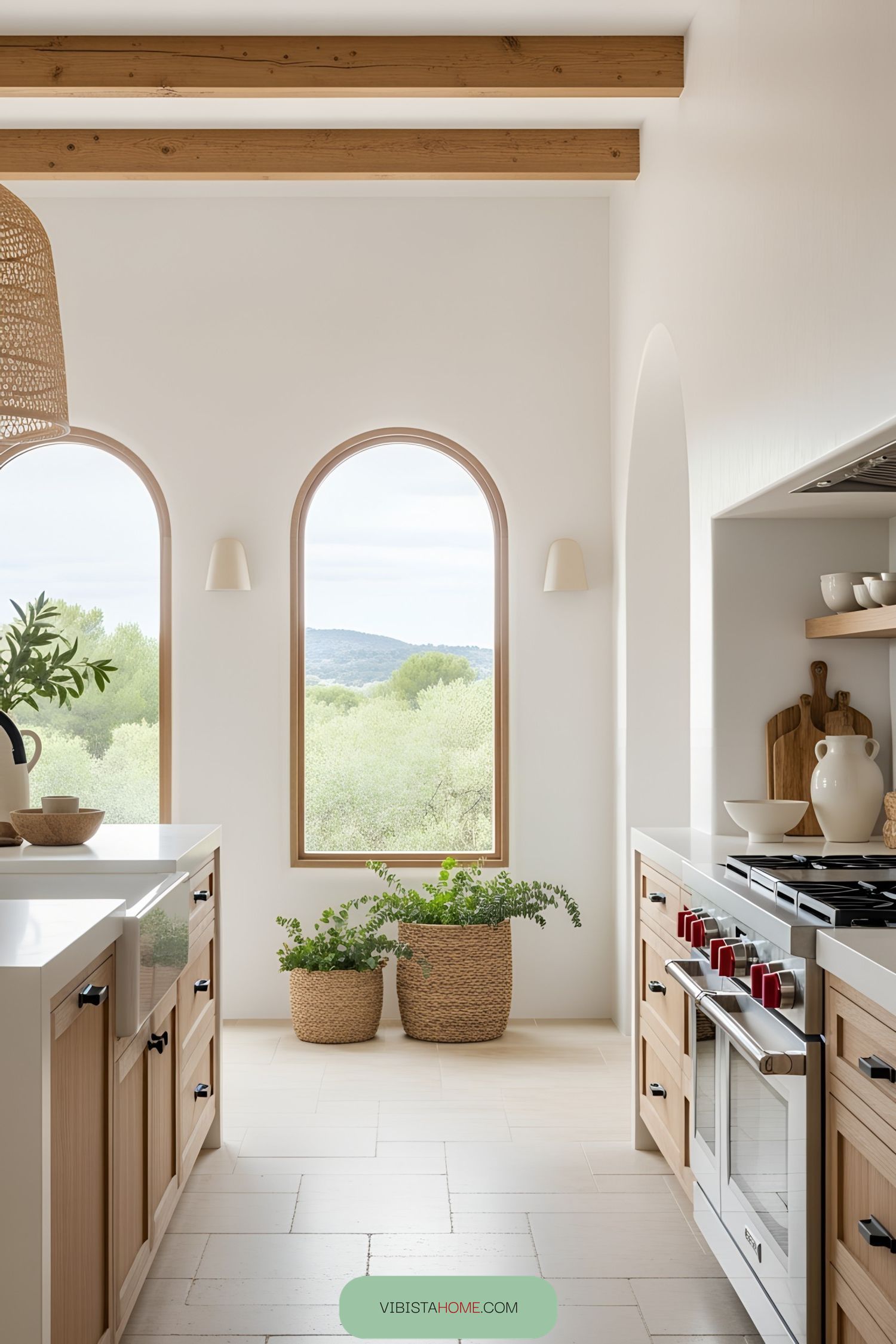Sunlit kitchen with arched windows and rustic accents