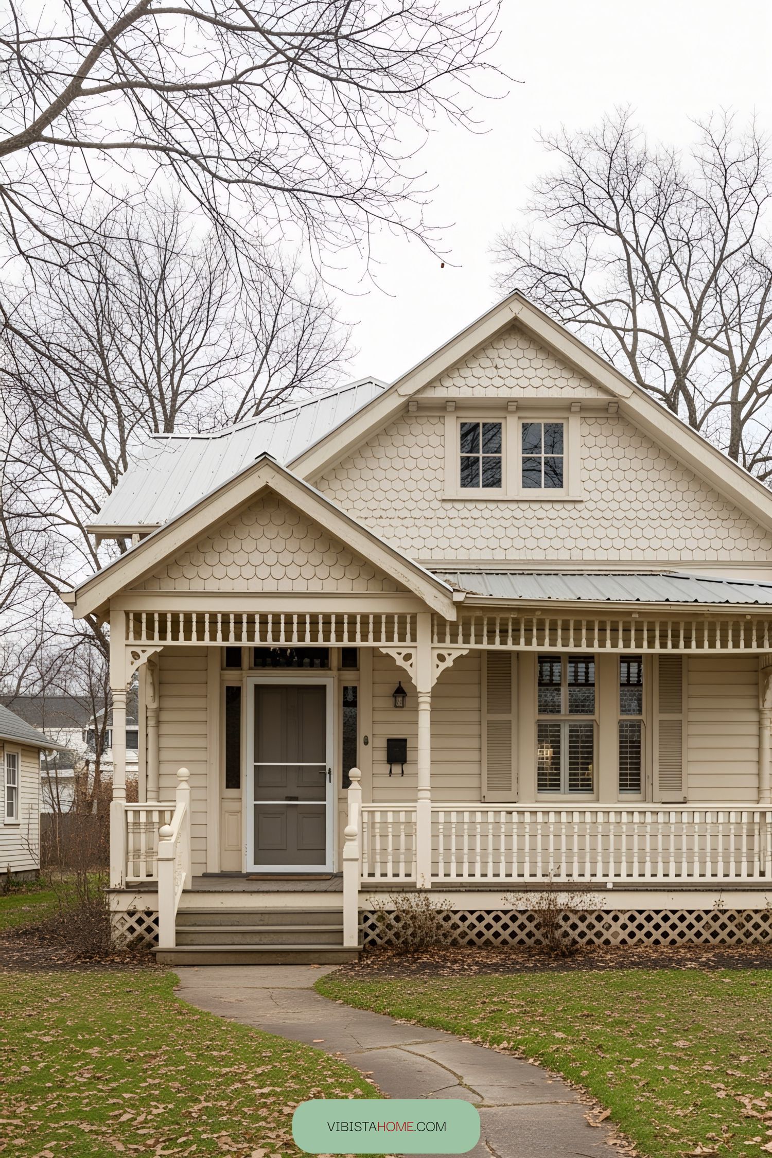 Cream-colored Victorian cottage with architectural details