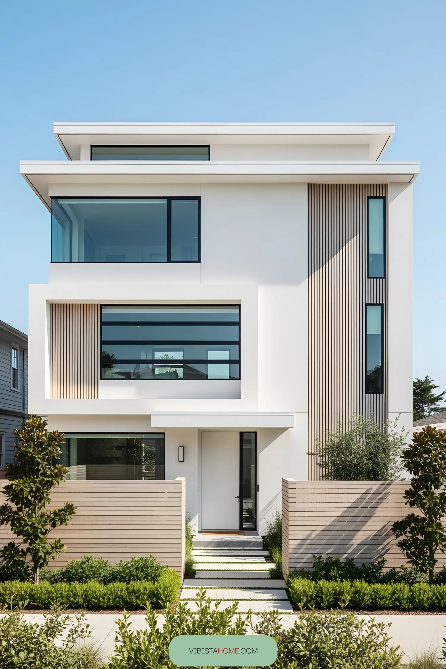 Modern beachfront house with sleek facade and lush greenery