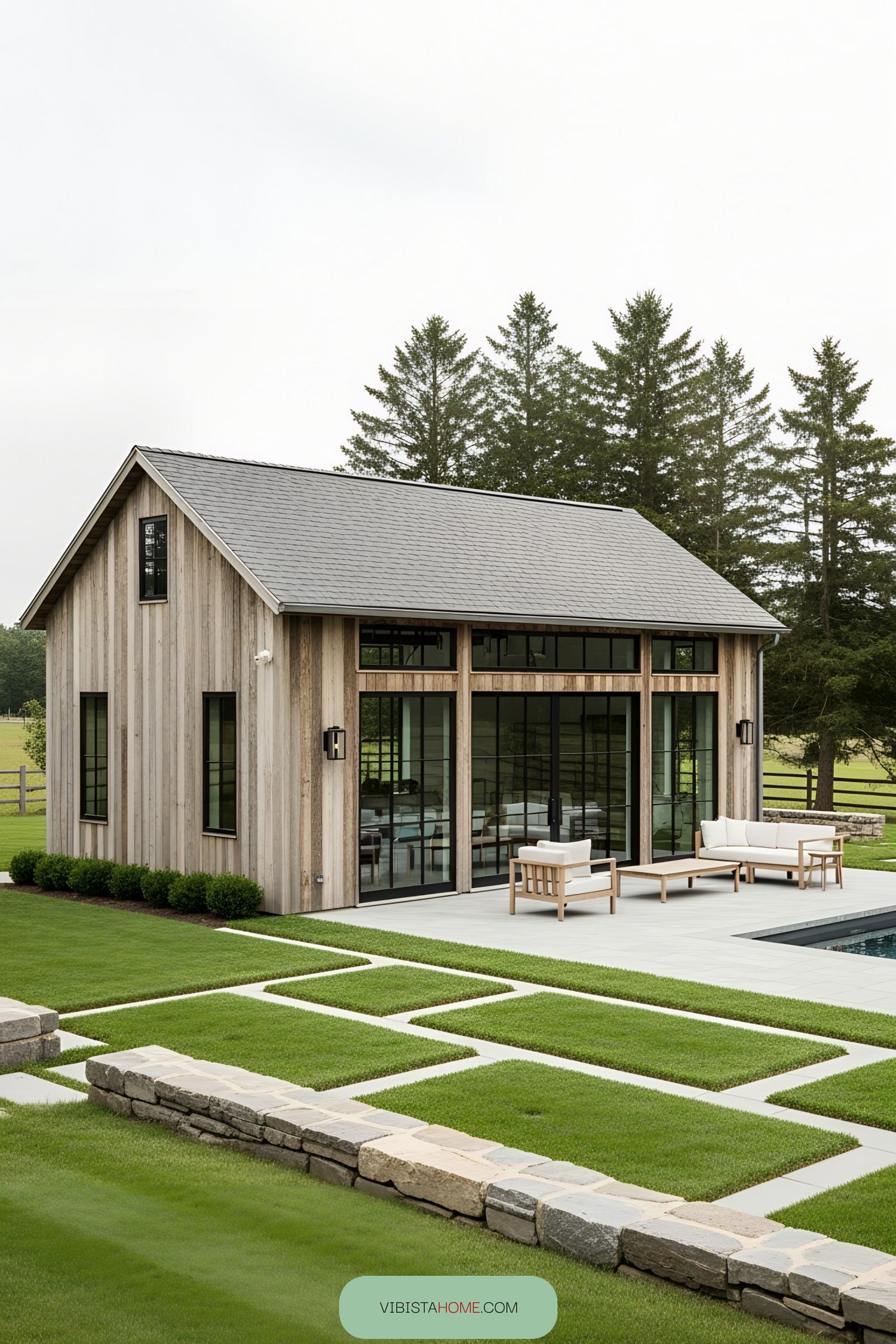 Small wooden pool house with glass doors and patio seating