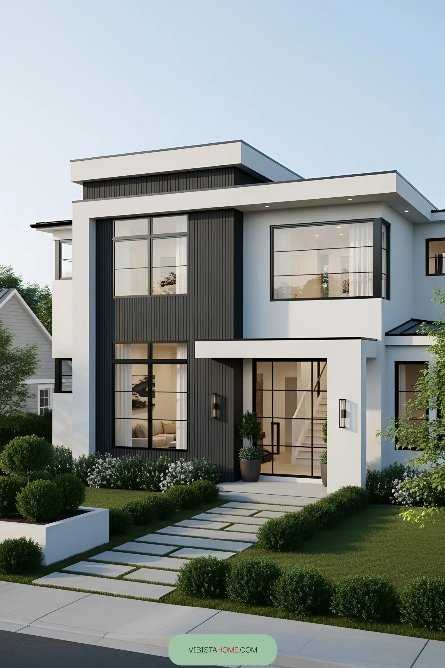 Modern house with large windows and lush landscaping