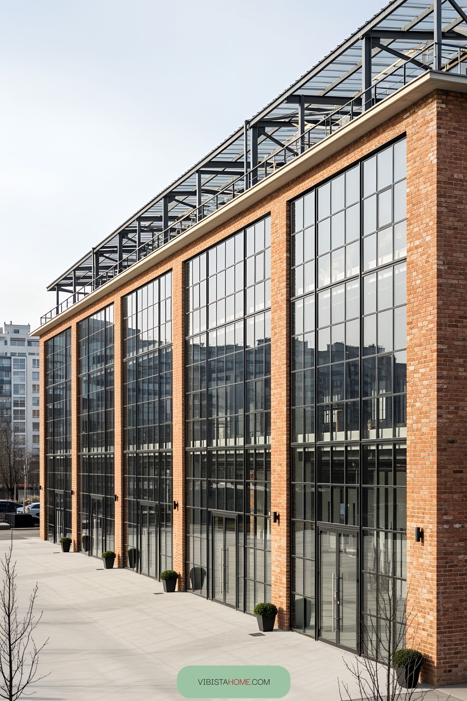 Modern industrial building with large glass windows and brick walls