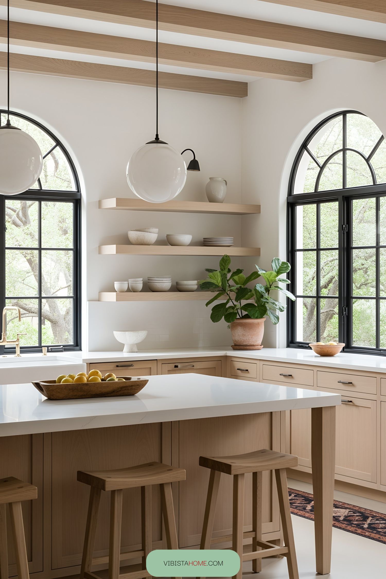 Open Spanish kitchen with natural light, wooden beams, and greenery