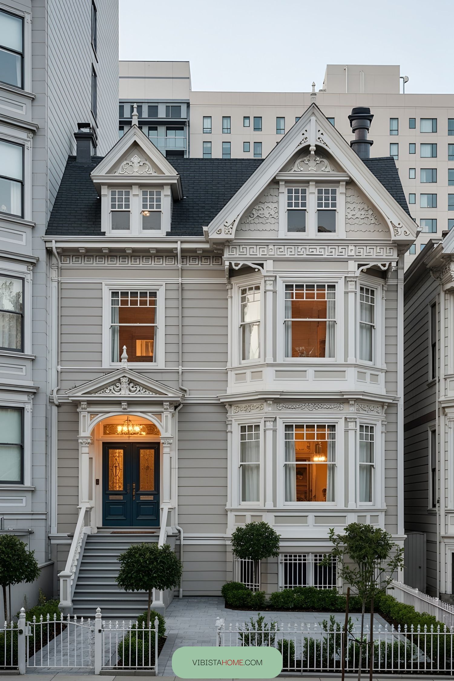 Elegant Victorian house with ornate details and lush shrubs