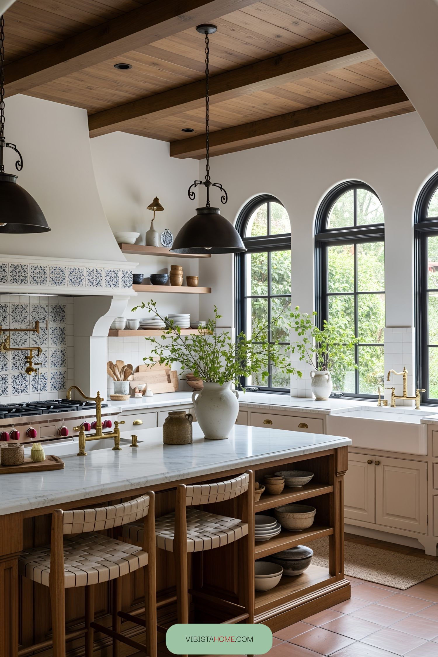Spanish-style kitchen with arched windows and wooden beams