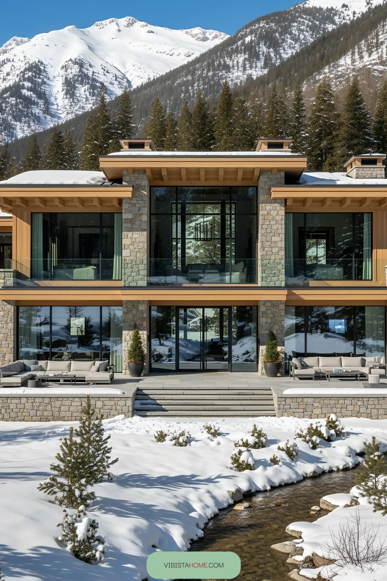 Elegant stone and glass chalet with snowy mountains