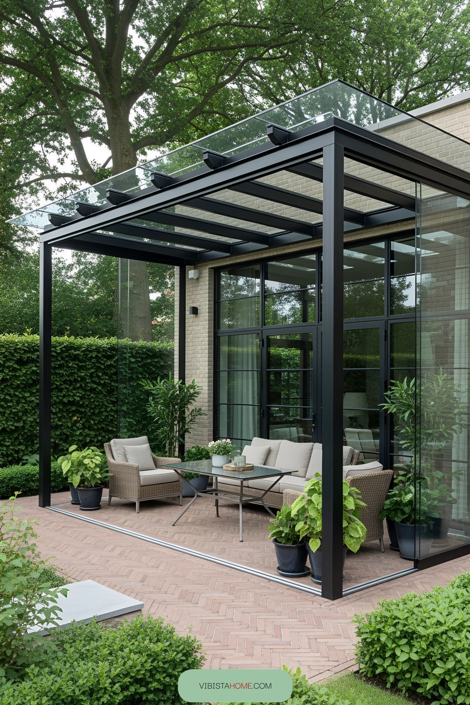 Modern terrace with glass canopy and lush plants