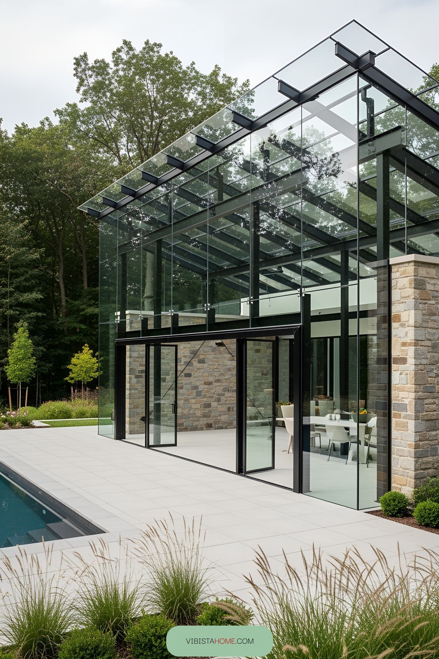 Spacious and modern glass terrace overlooking a pool