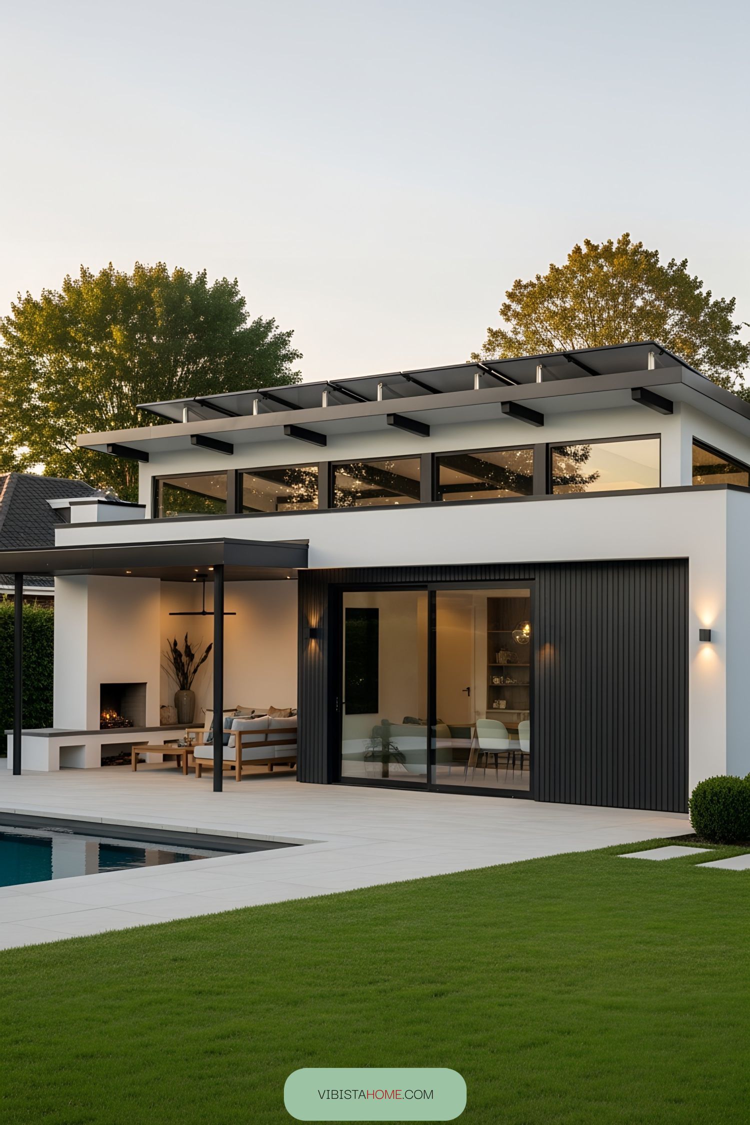 Stylish pool house with sleek design and green lawn