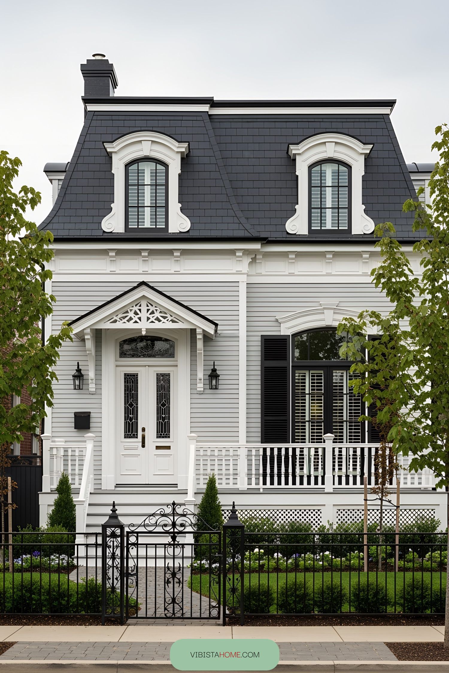 Small Victorian house with ornate details and lush garden