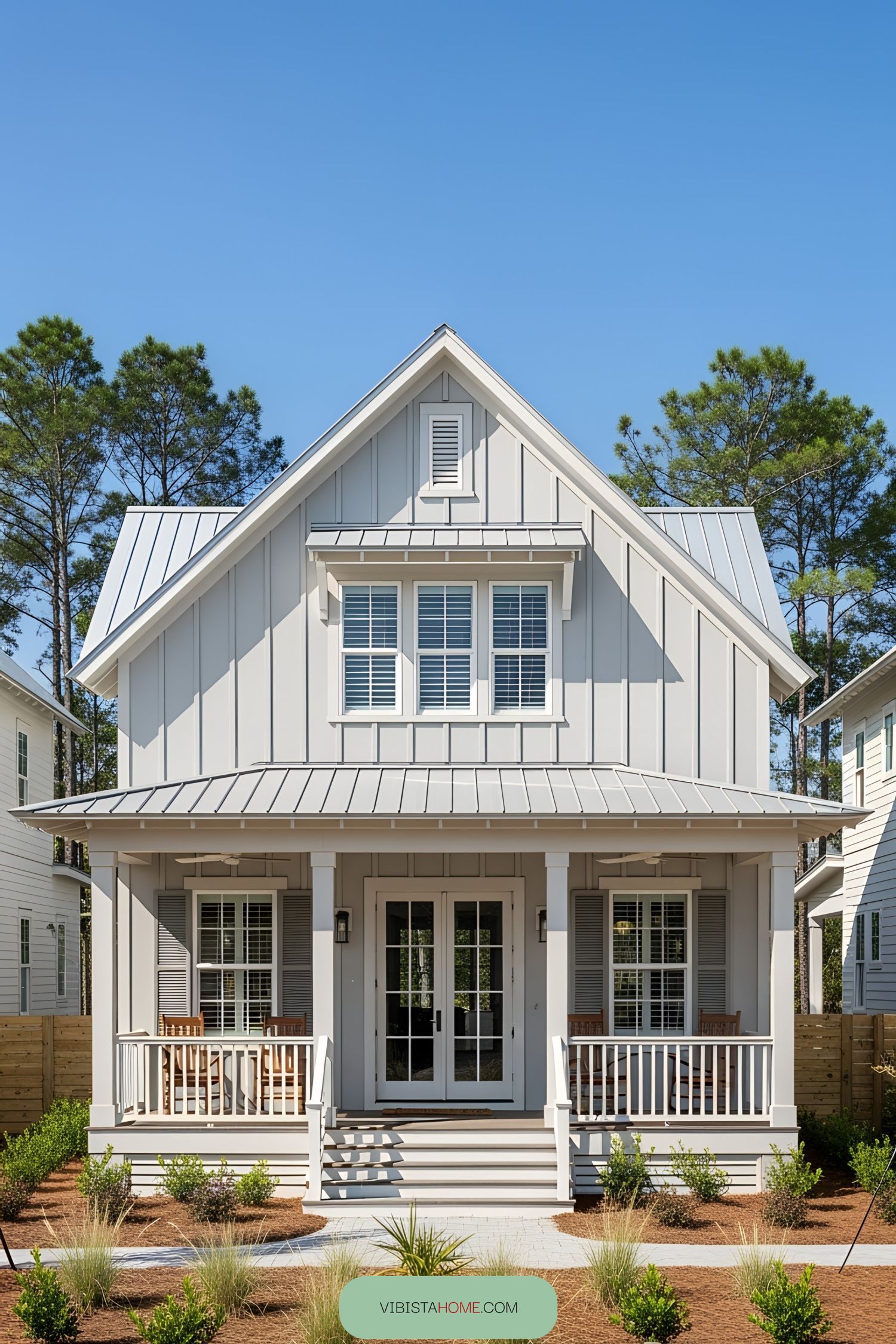 Compact coastal bungalow with white siding and covered porch
