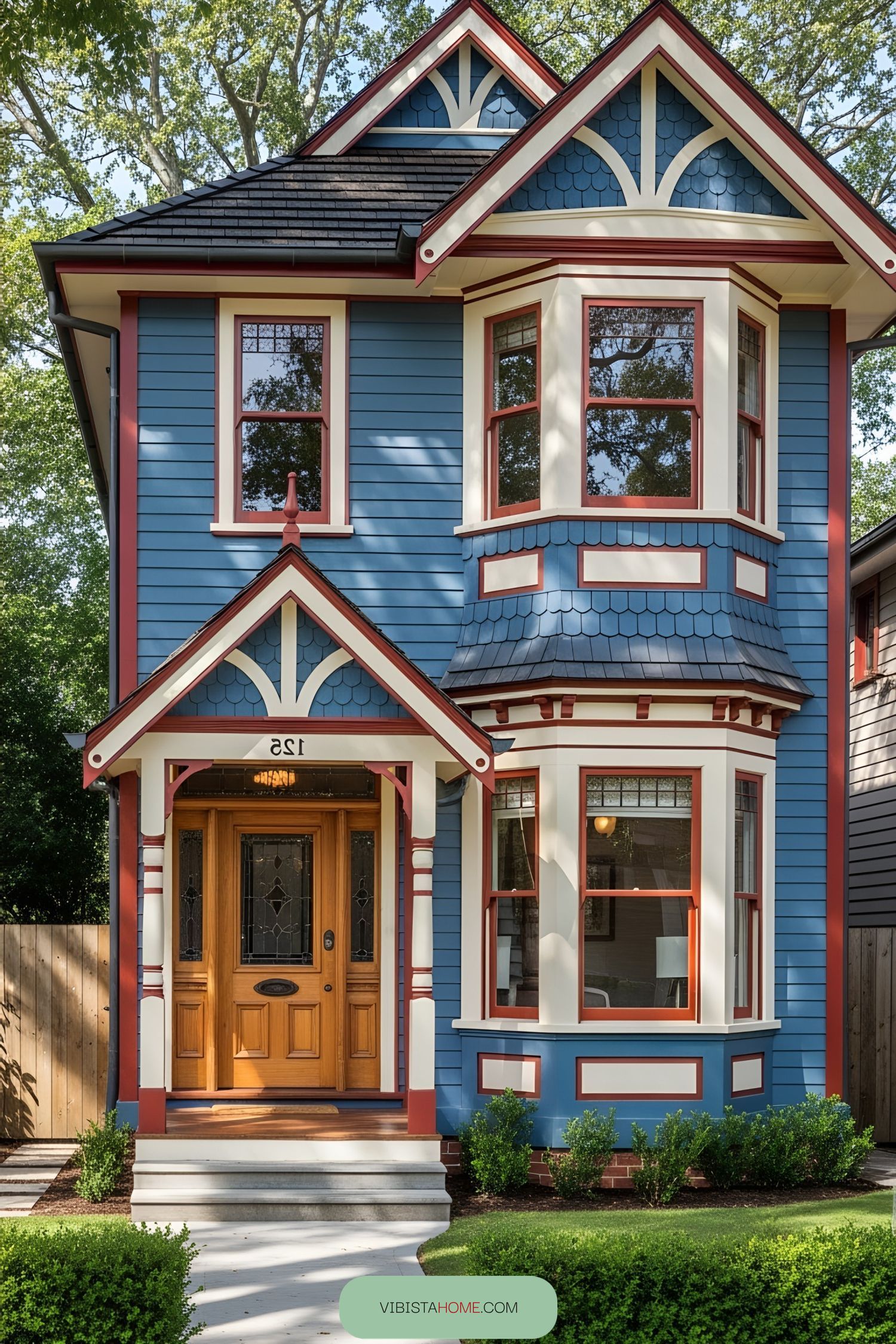 Charming small Victorian home with bright blue exterior and red trim