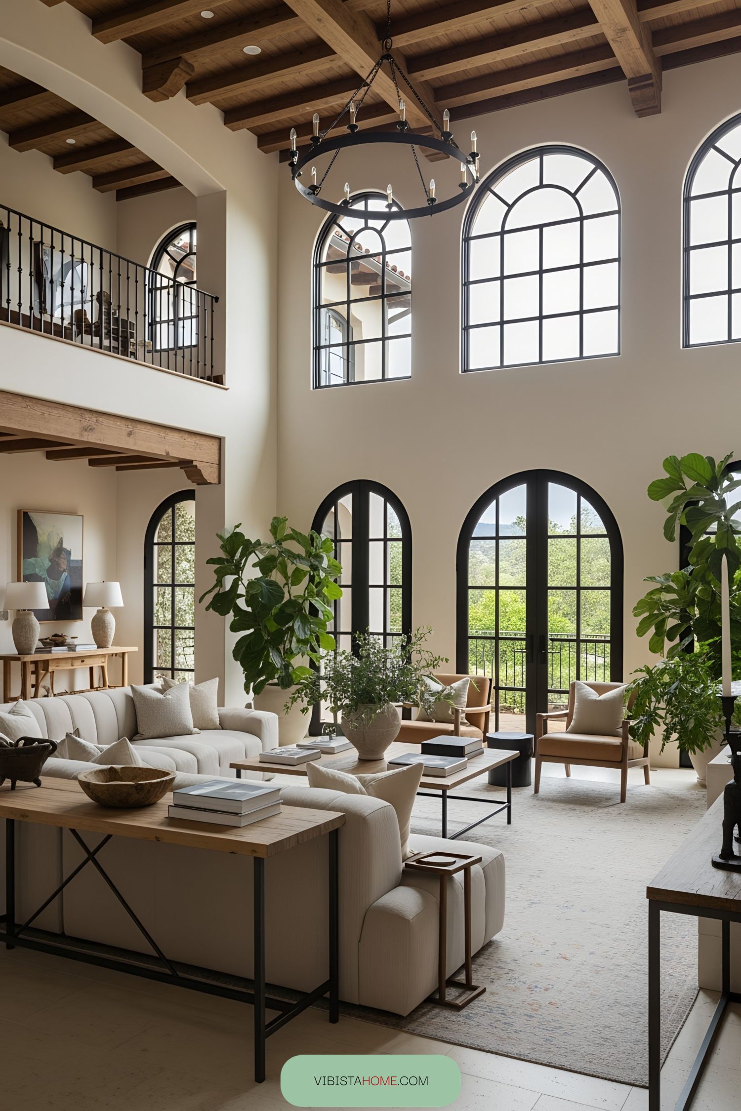 Bright Spanish-style living room with large arched windows and wooden beams